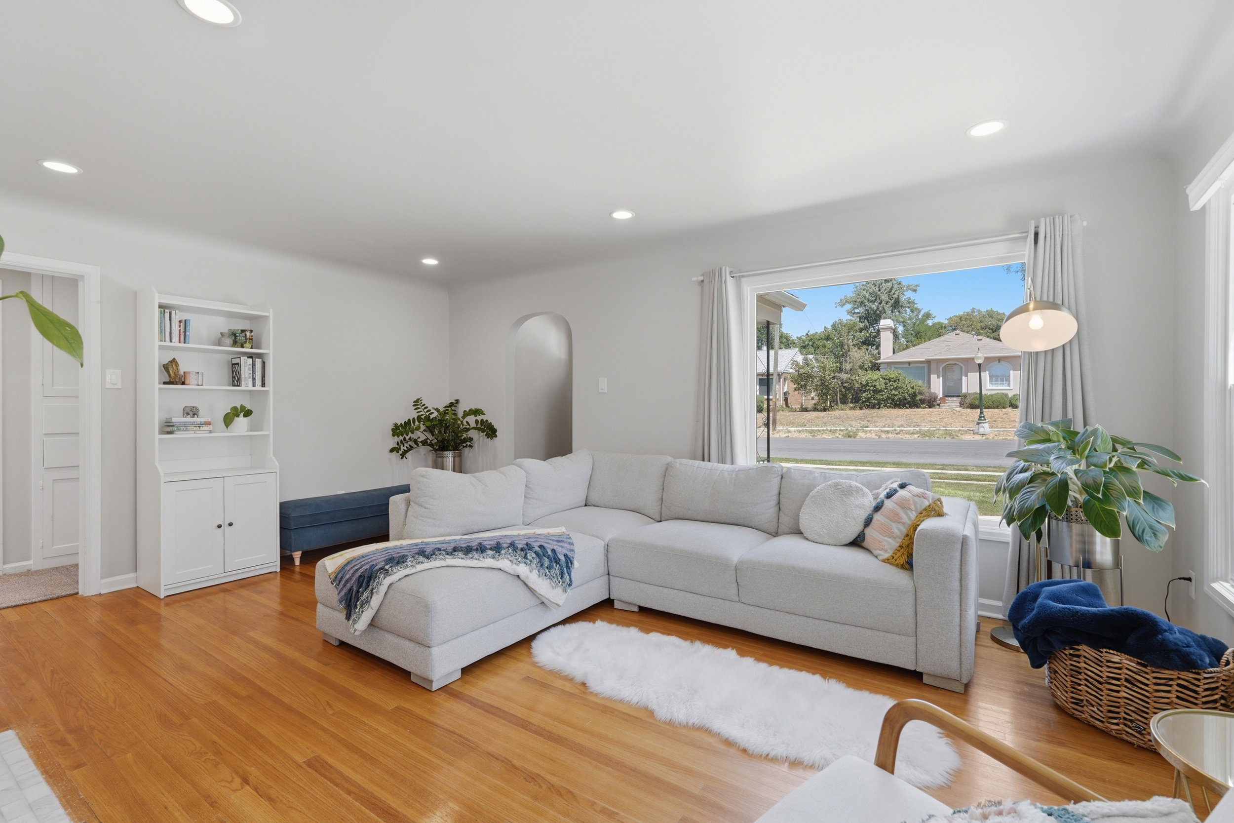 Bright living area featuring wood-finish flooring, recessed lighting, and a prominent window