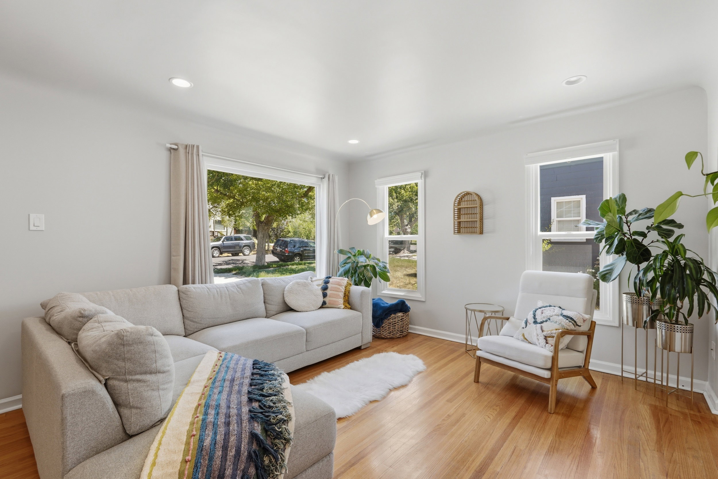 Open-concept living space featuring wood-finish flooring, recessed lighting, and multiple windows