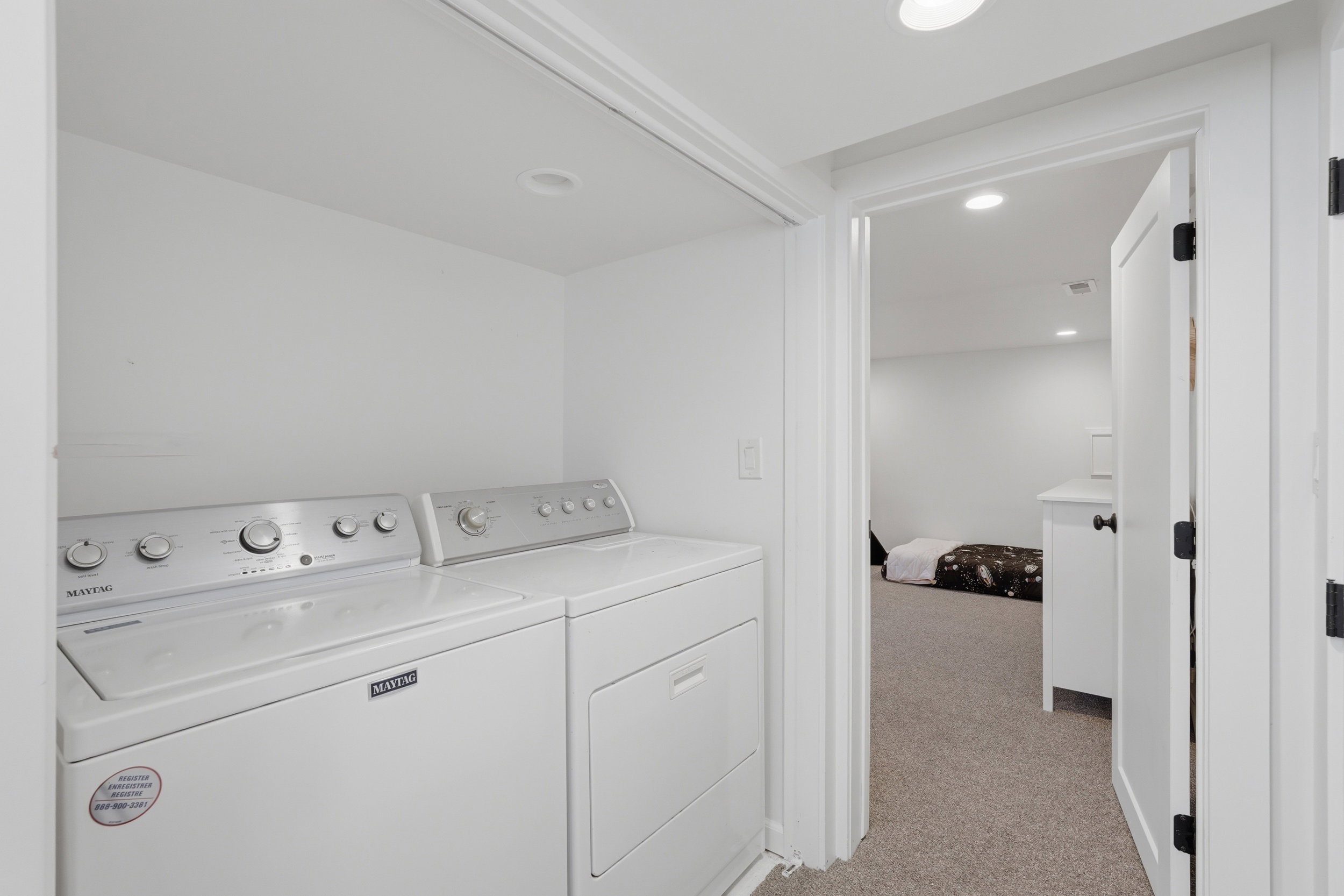 Dedicated laundry area with recessed lighting and a full-size washer and dryer