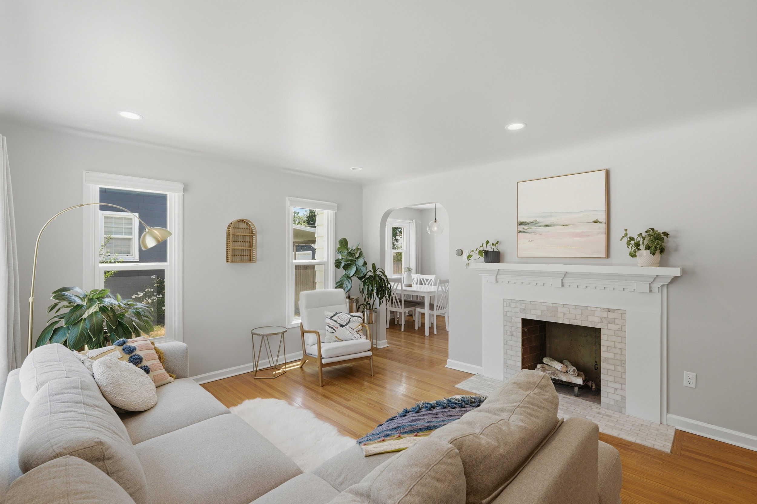 Living area featuring wood-finish flooring, recessed lighting, and a decorative fireplace with a tiled surround