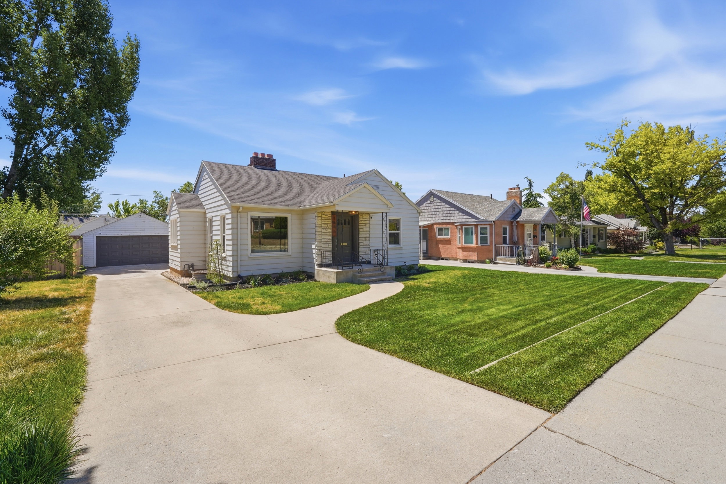 Craftsman-style home featuring white siding and a covered front porch