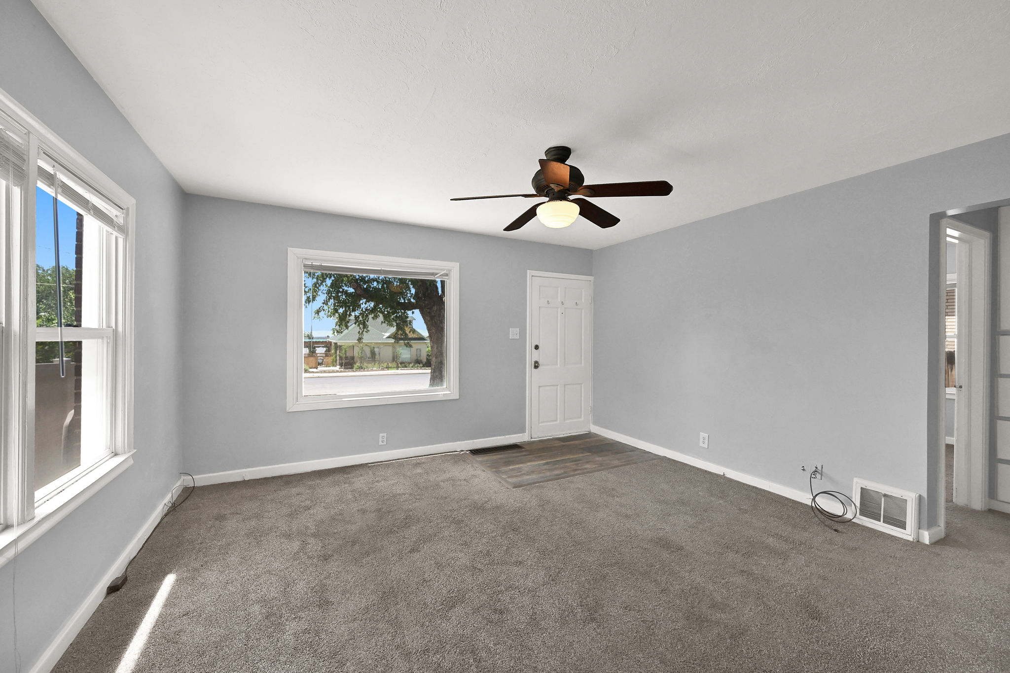 Living area featuring light gray walls and dark gray carpet