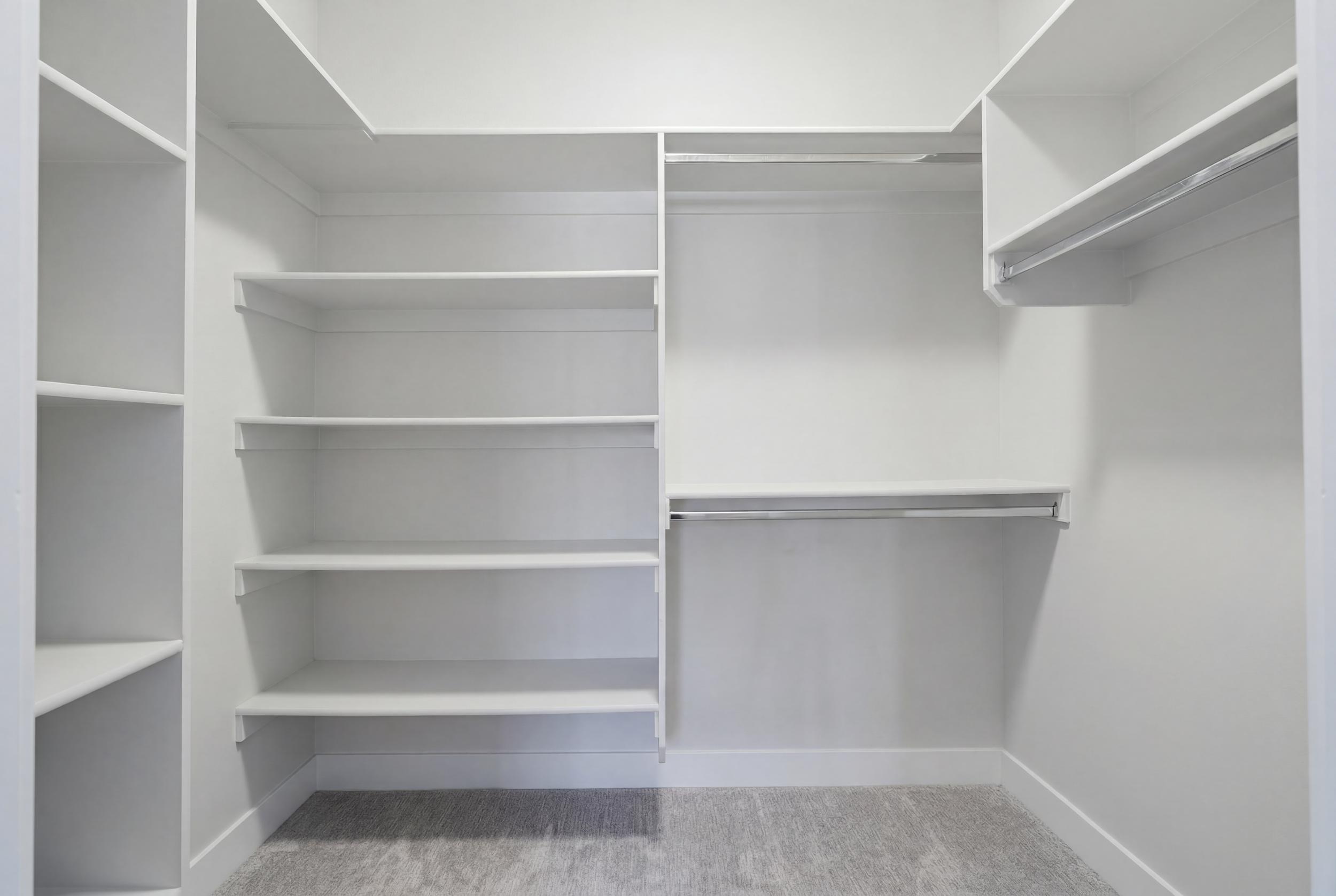 Custom closet system featuring multiple shelving units and integrated hanging rods