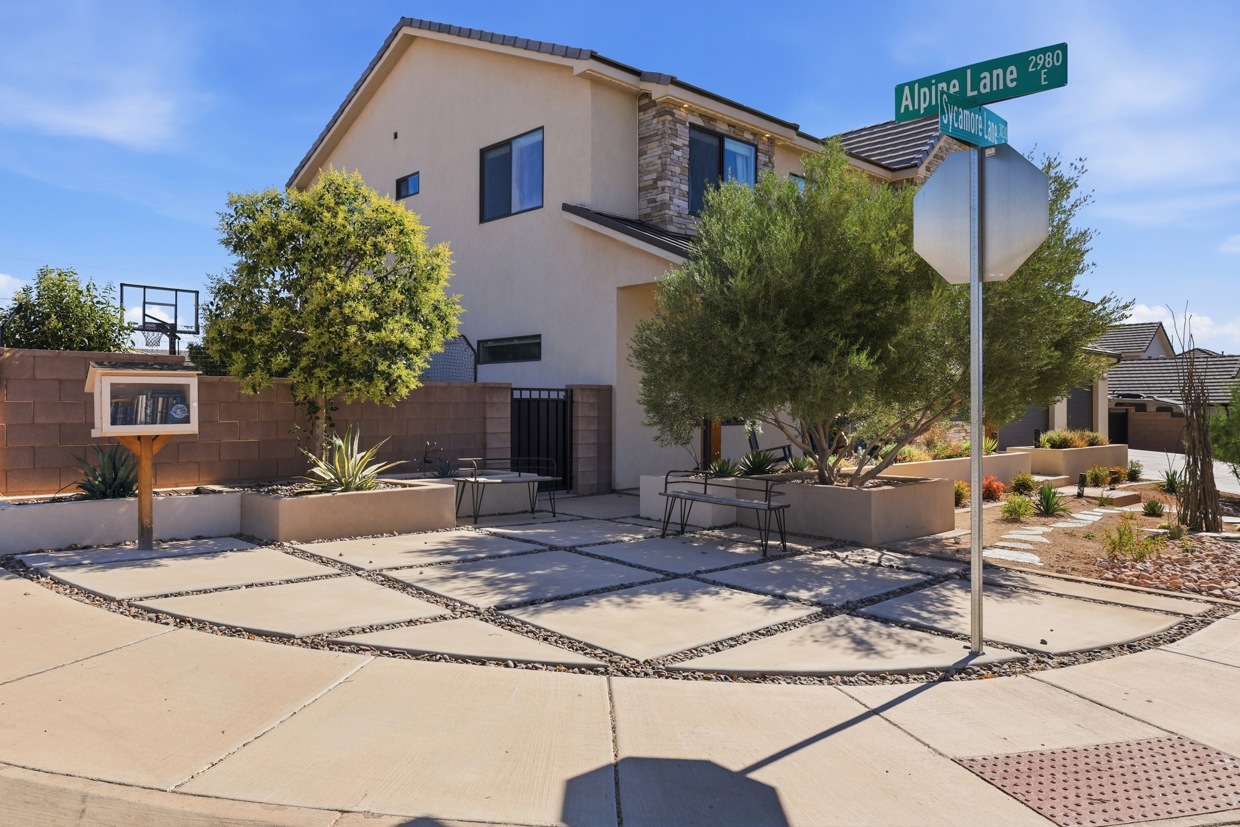 Contemporary stucco exterior with stone accents and a tile roof