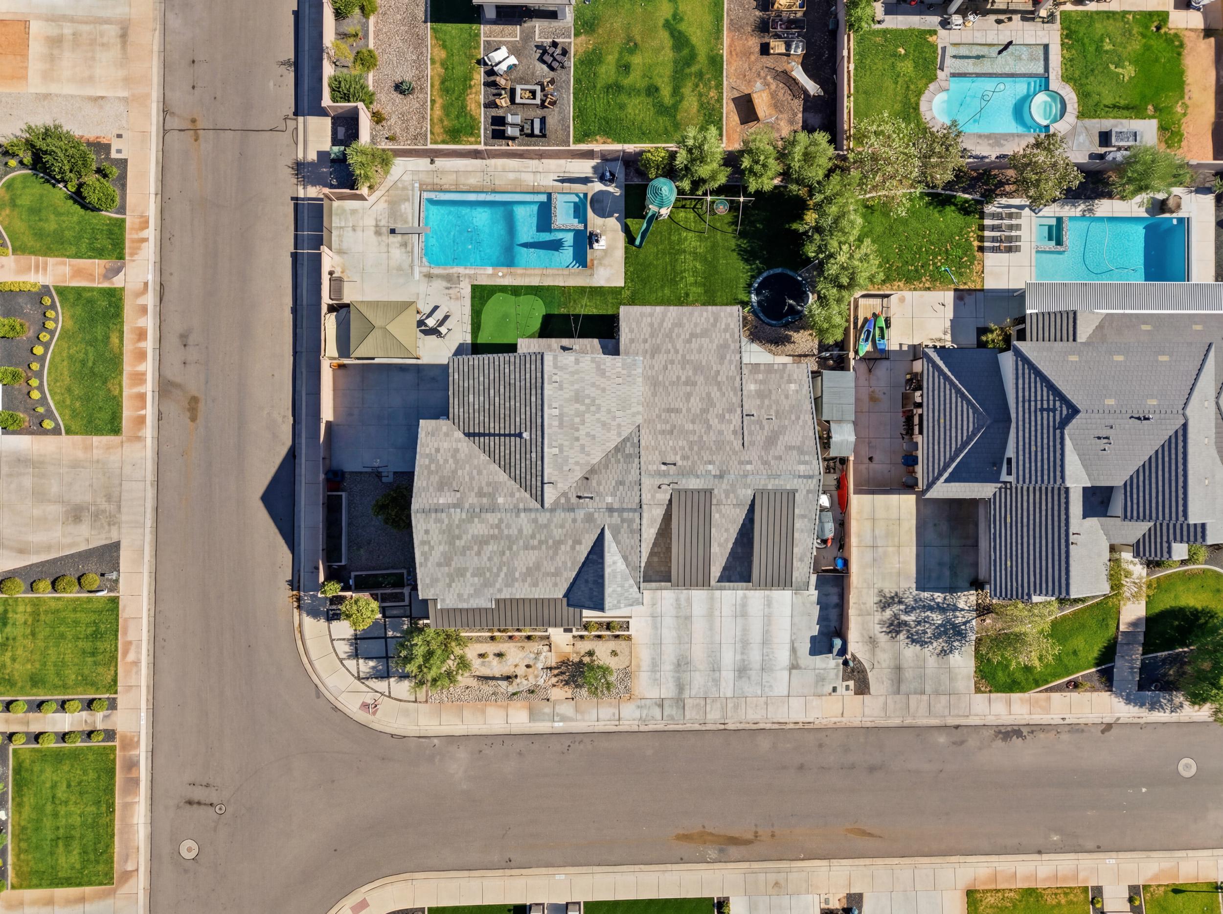 Corner lot property featuring a large backyard, private swimming pool, and dedicated patio area