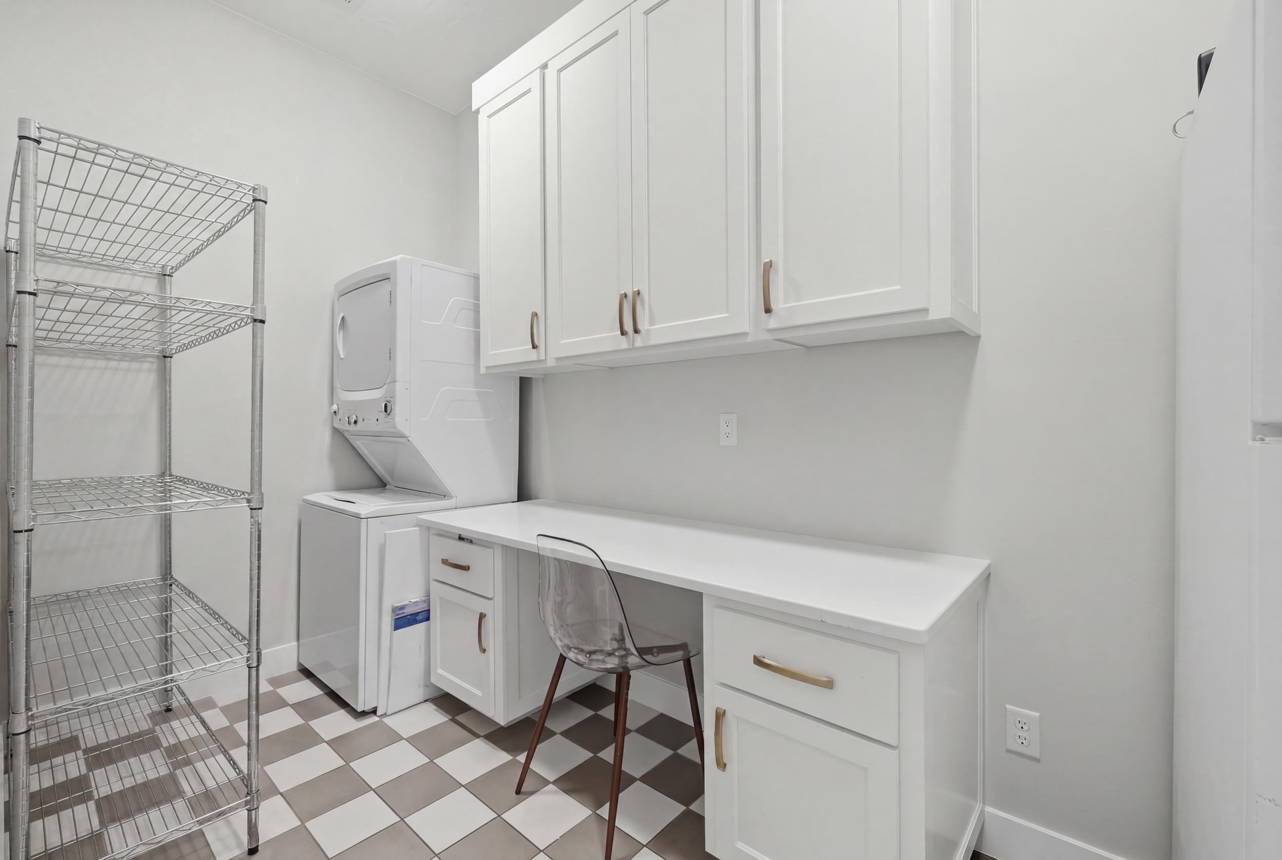 Laundry area featuring checkerboard tile flooring