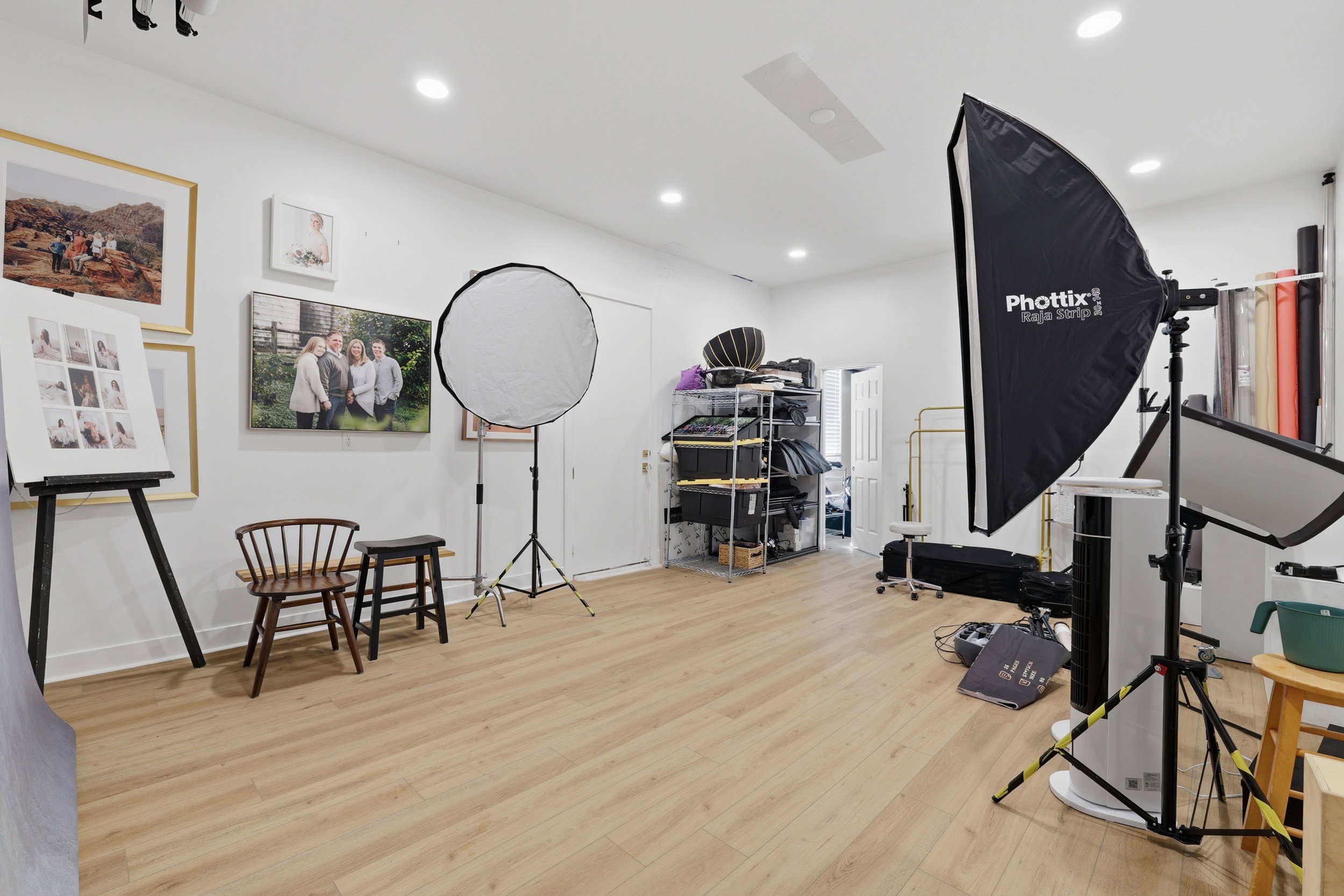 Spacious room featuring wood-finish flooring, white walls, and recessed lighting
