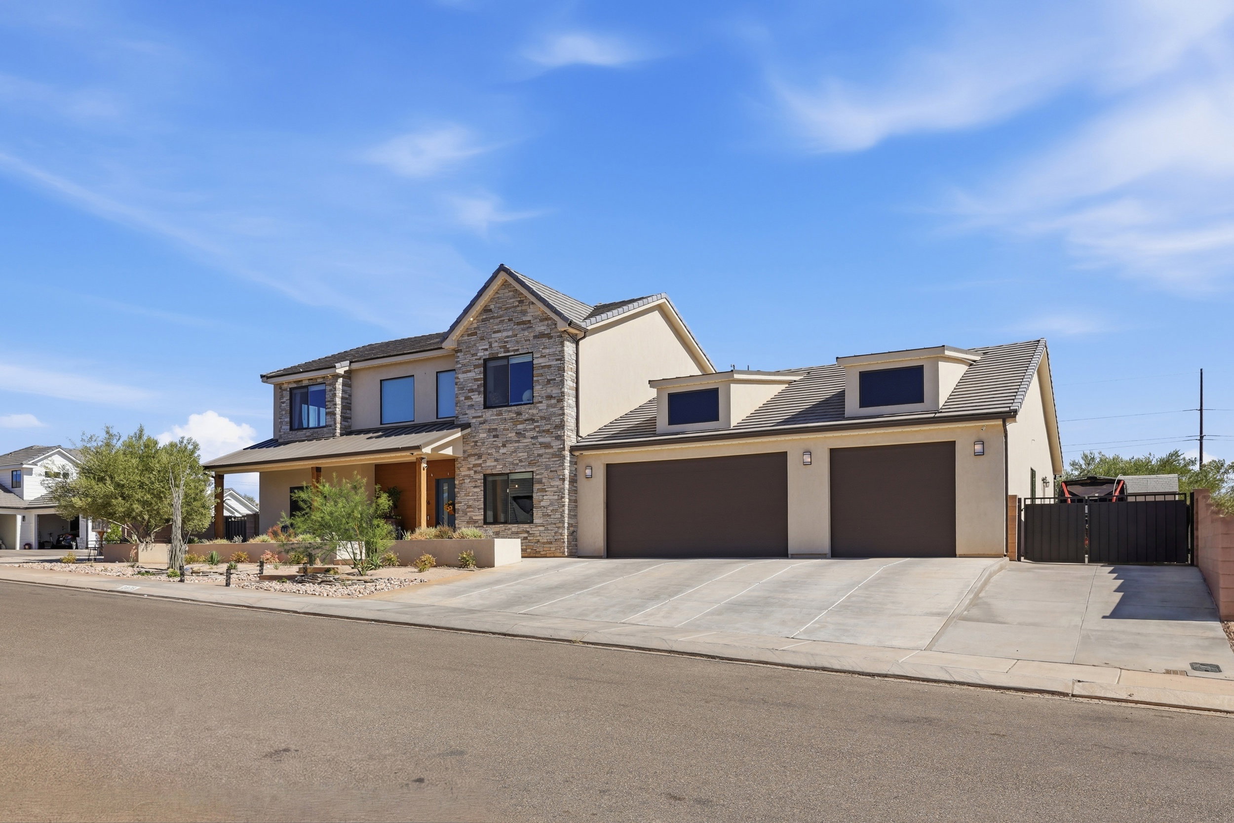 Stone veneer and stucco exterior with a prominent two-car garage