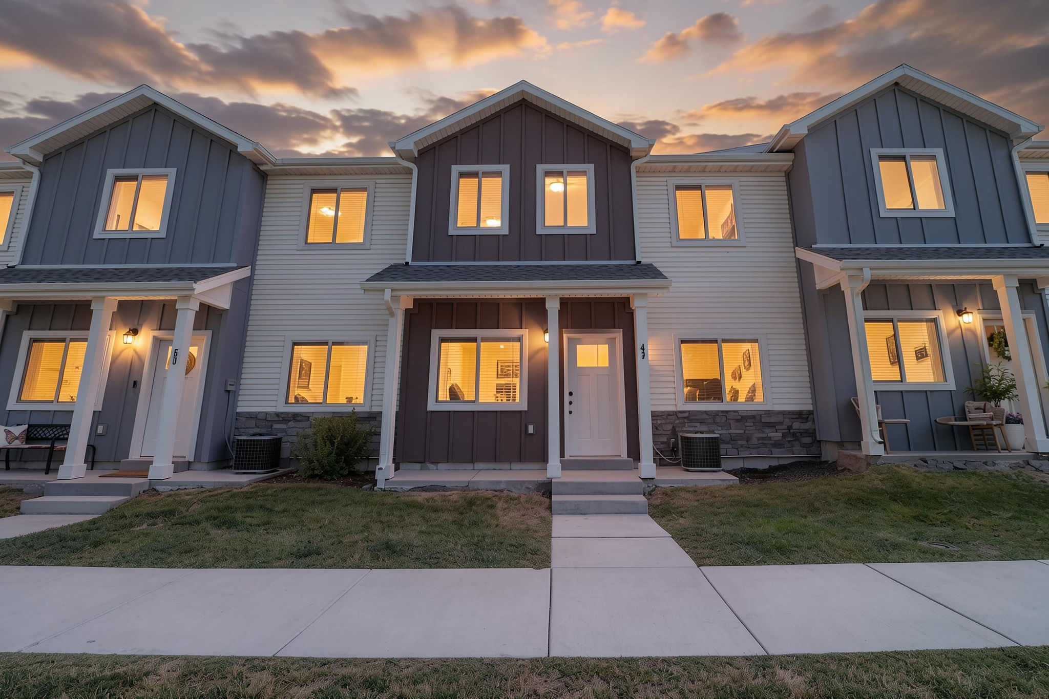 Contemporary townhome exterior featuring a two-story design with varied siding textures