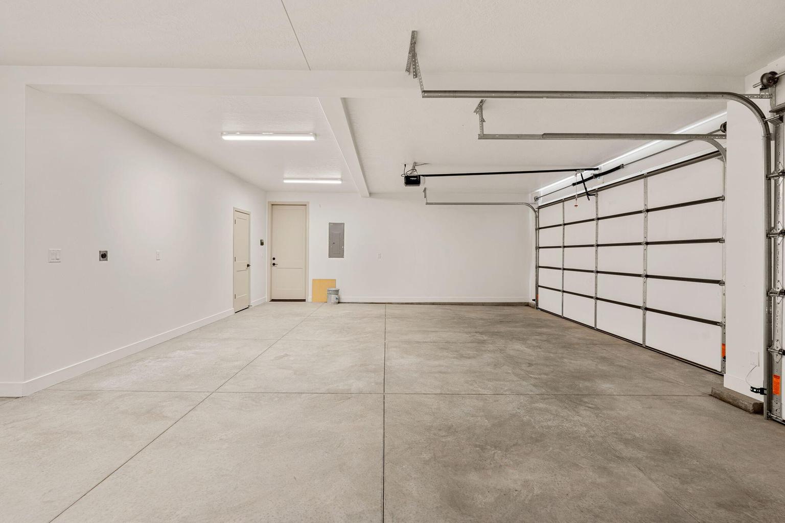 Spacious garage featuring concrete flooring and white walls