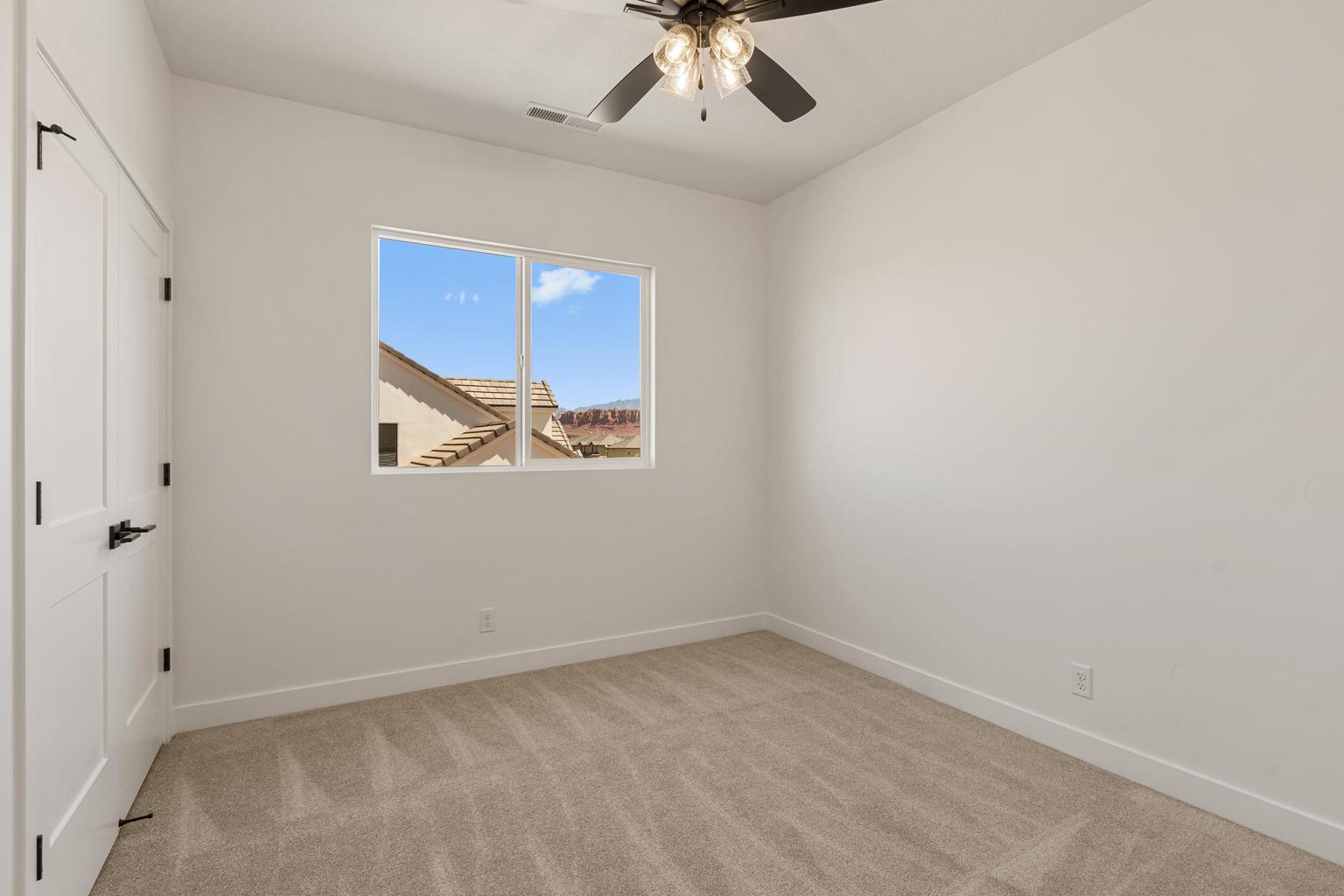 Bright room featuring neutral carpet flooring and white walls
