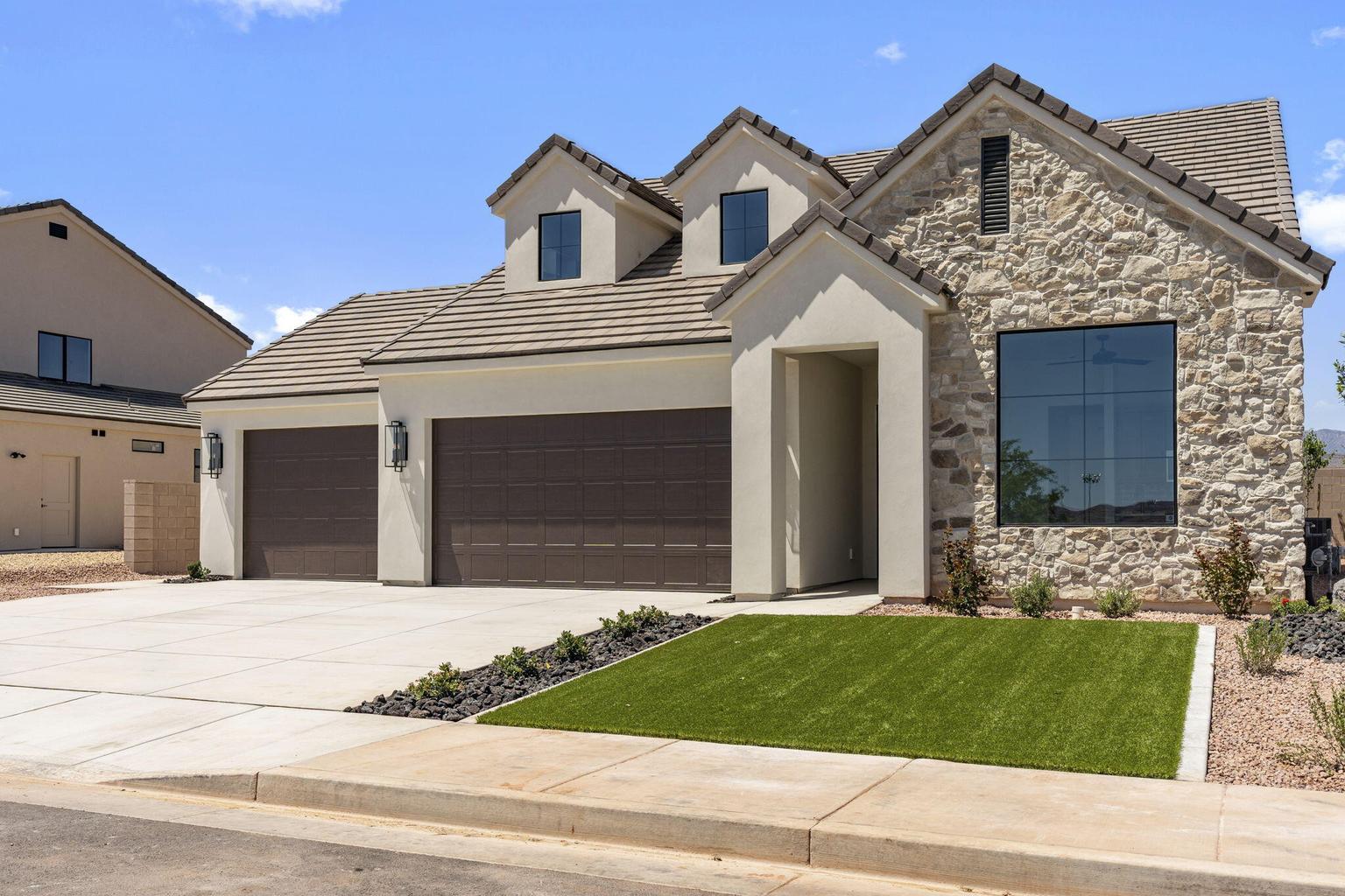 Exterior featuring stone facade detailing, a tiled roof, and a prominent front entrance