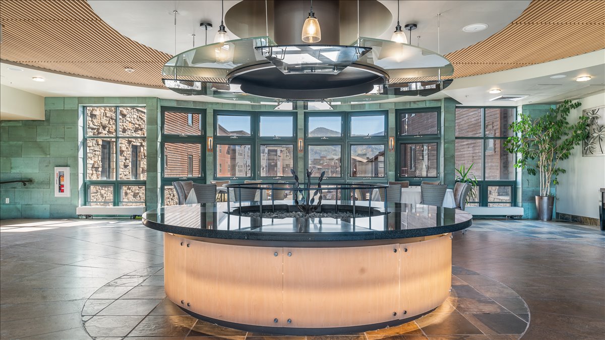 Central circular seating area with a dark countertop and illuminated base