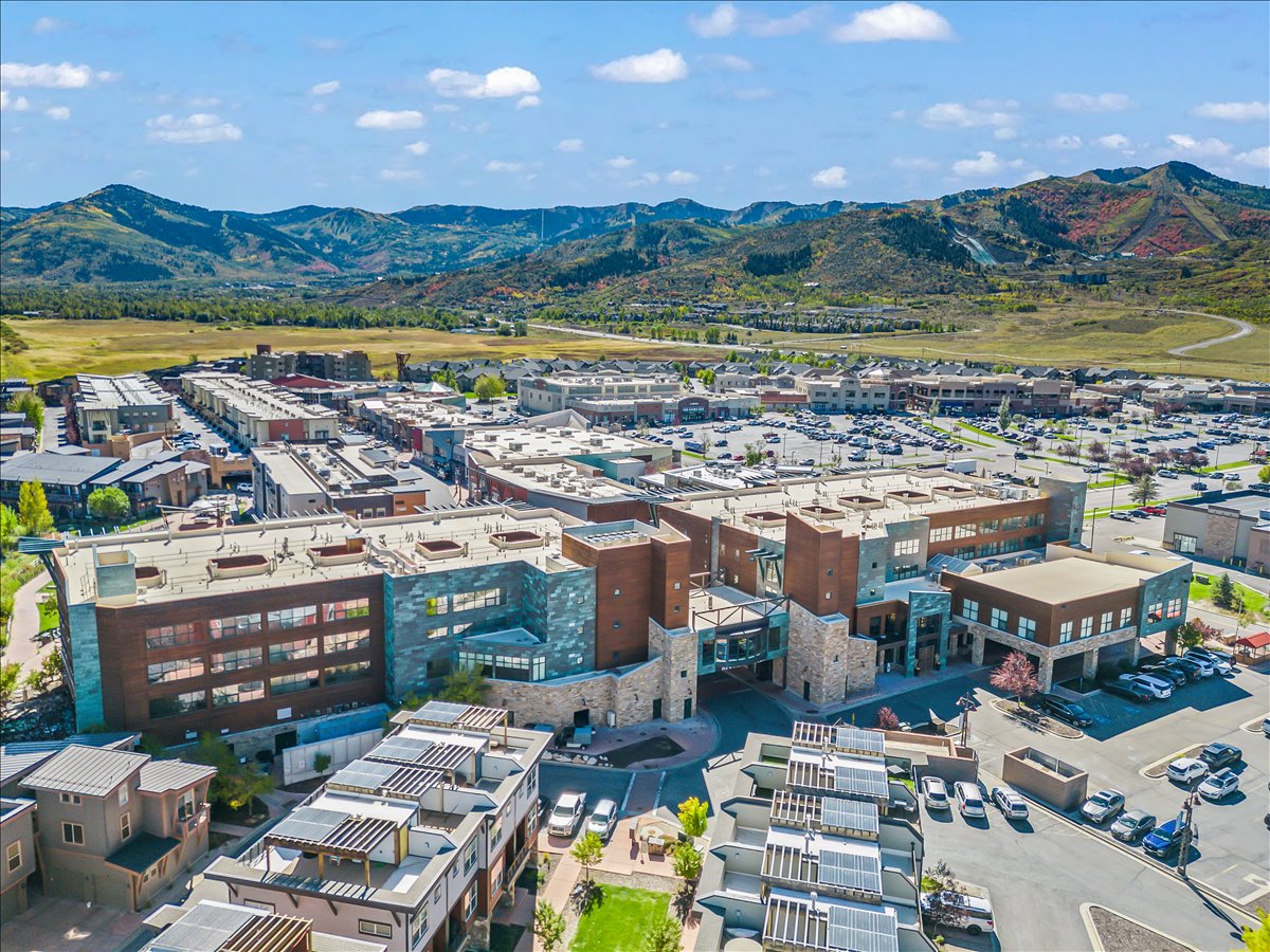 Expansive commercial and residential development featuring multi-story buildings with varied facades including stone, brick, and horizontal siding