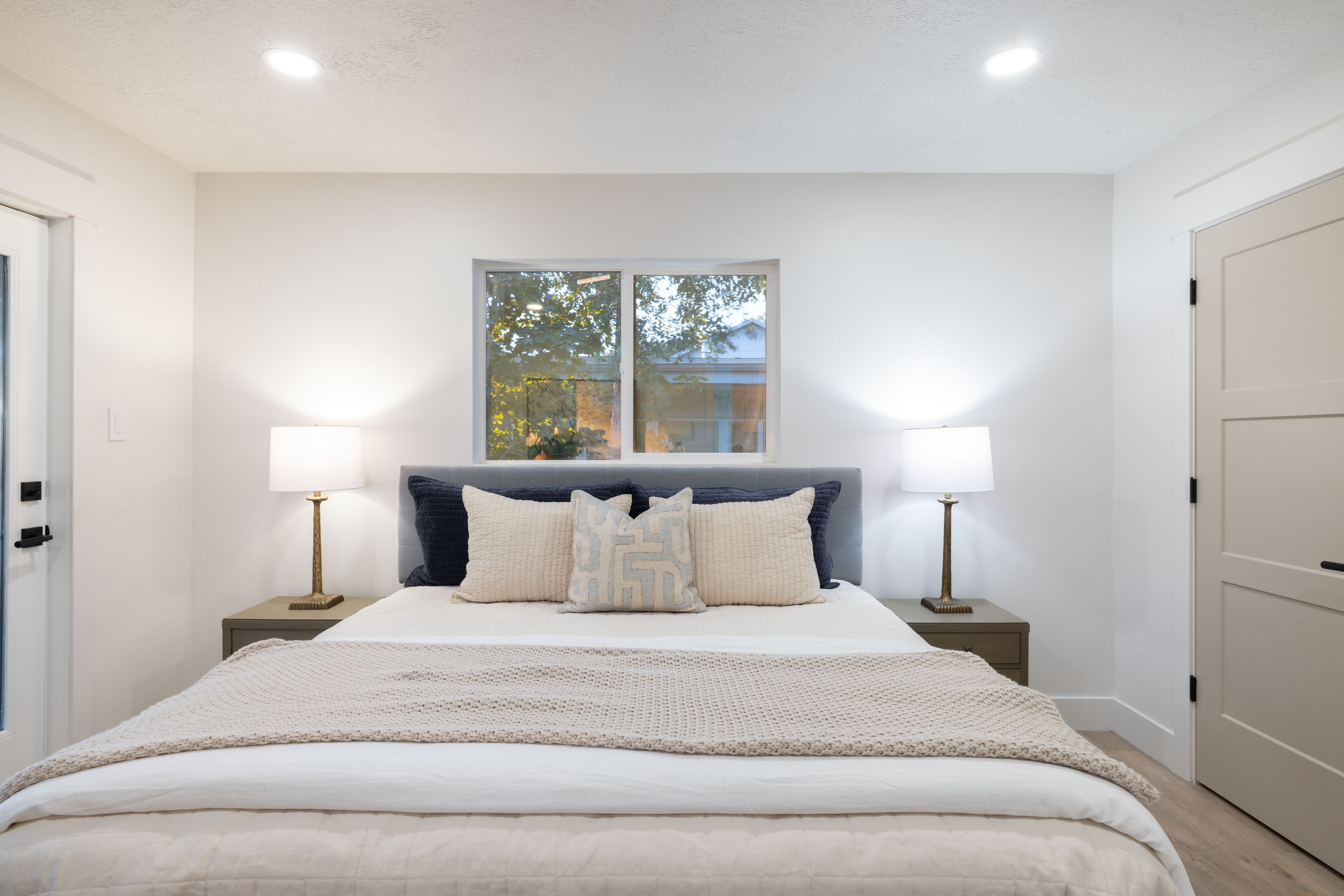Bright room featuring recessed lighting, a window, and wood-finish flooring