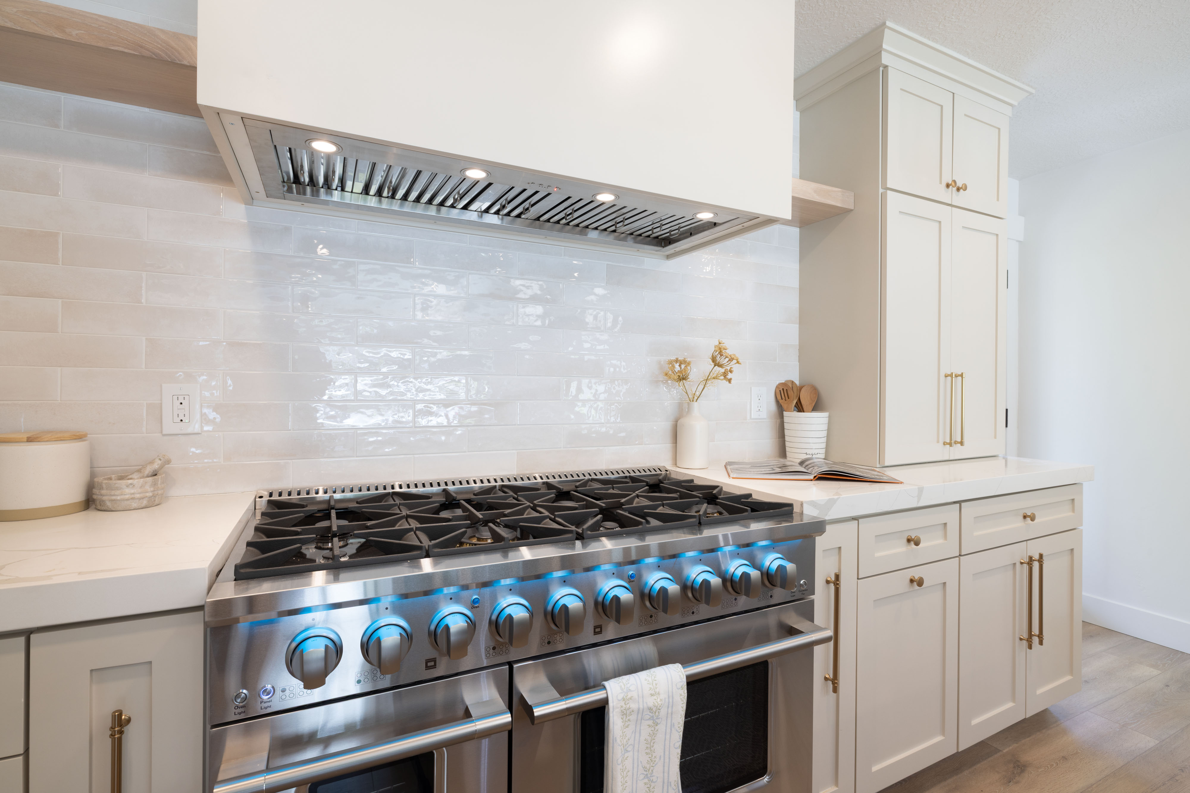 Stainless steel range with illuminated controls and a coordinating range hood