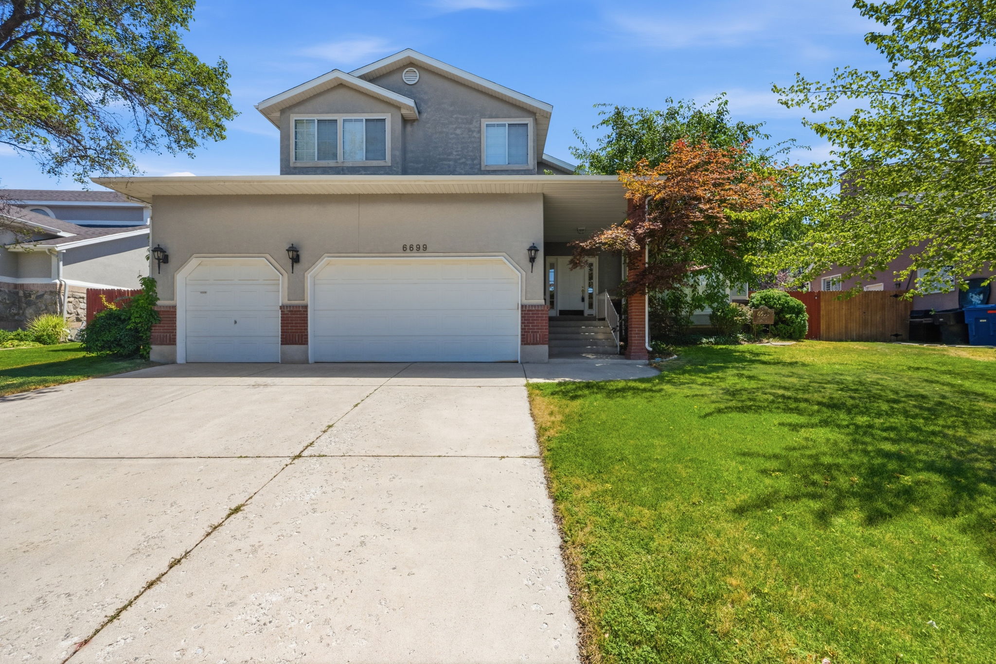 Stucco exterior with brick accents and a two-car garage