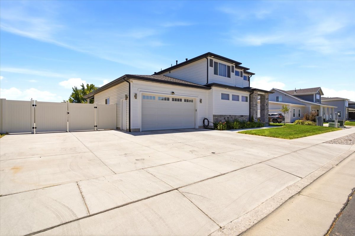 Contemporary two-story exterior featuring white siding and stone accents