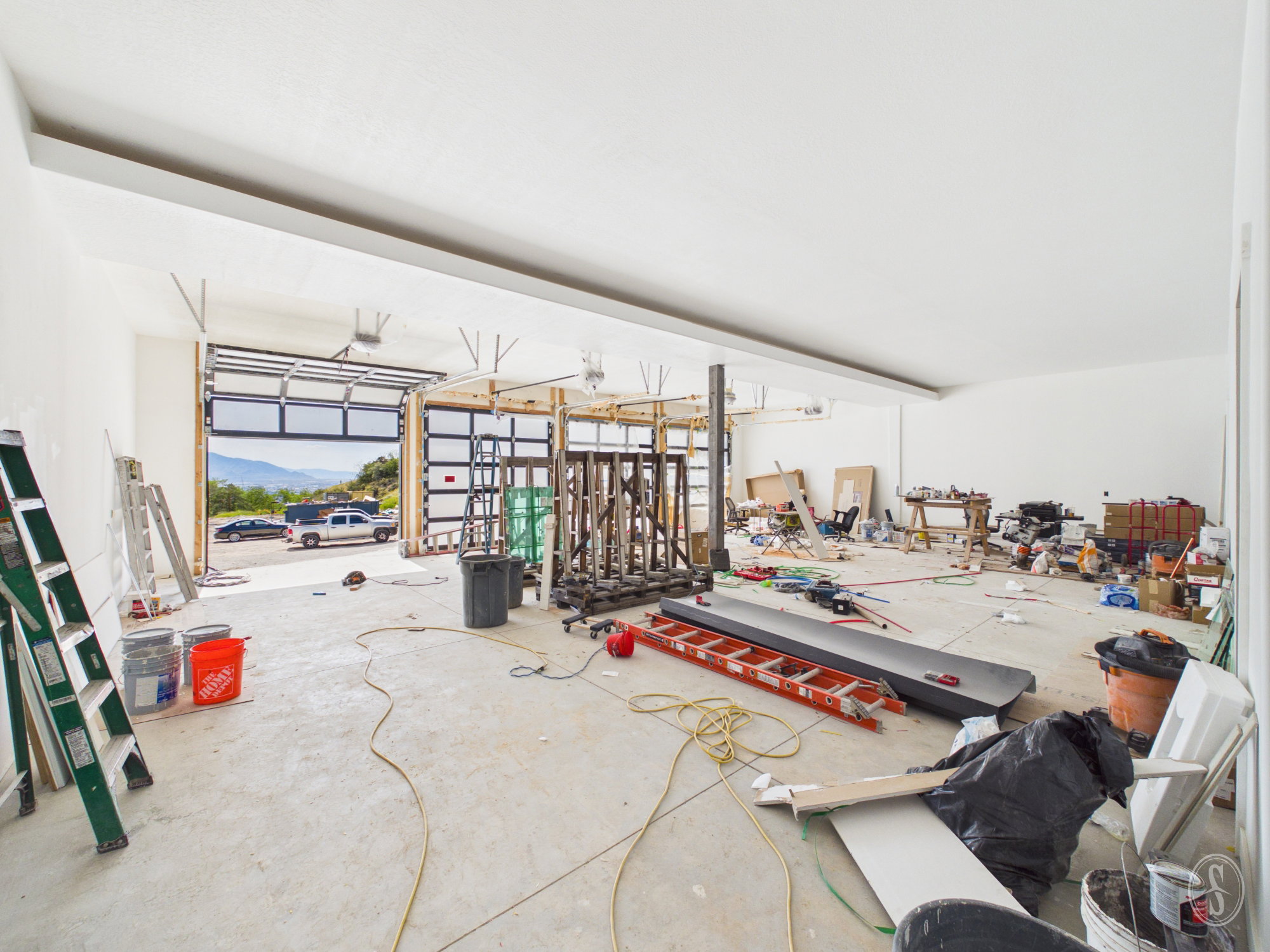 Spacious interior with concrete flooring and white walls