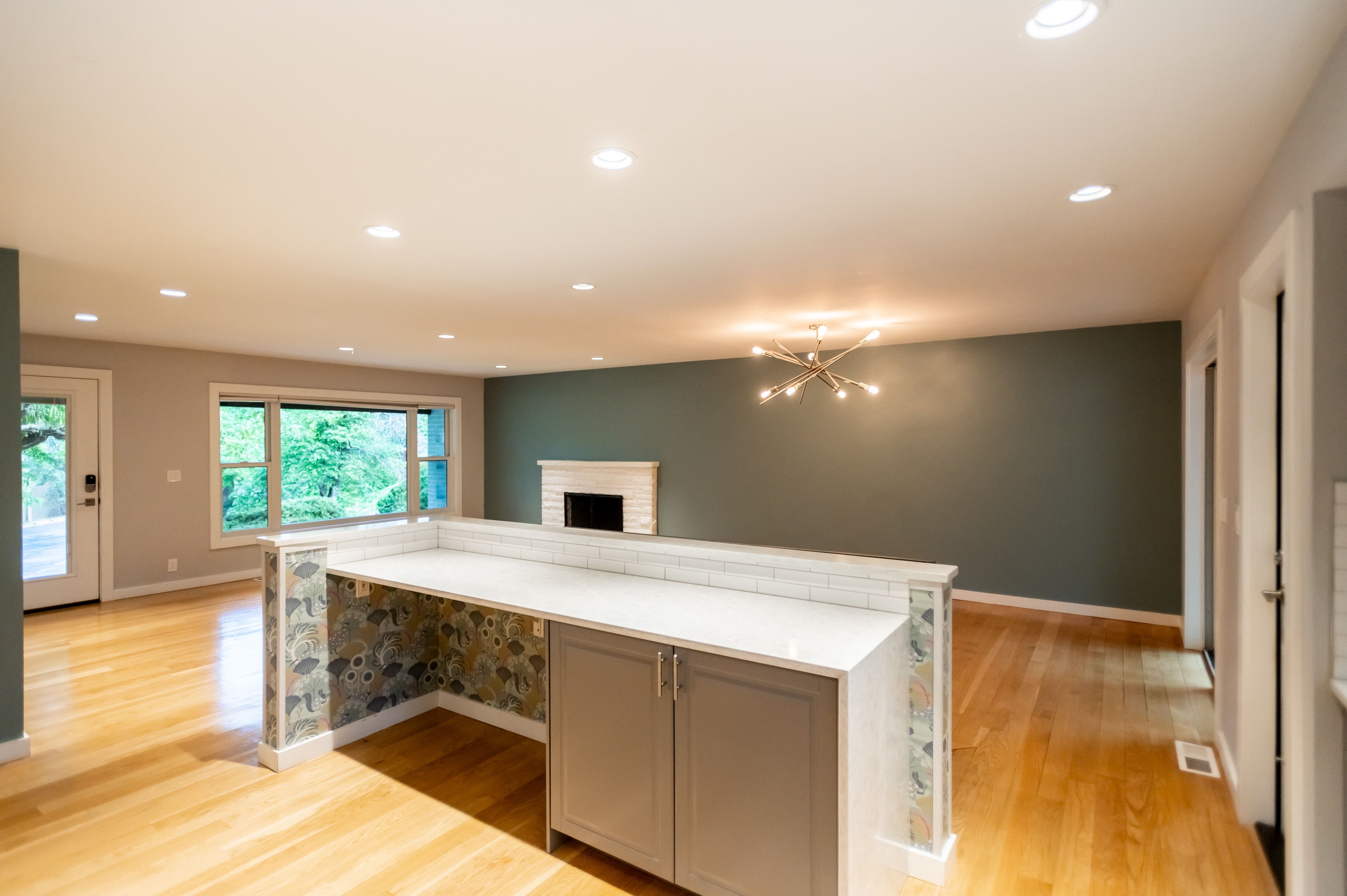 Interior living space featuring wood-finish flooring, recessed lighting, and a contemporary chandelier