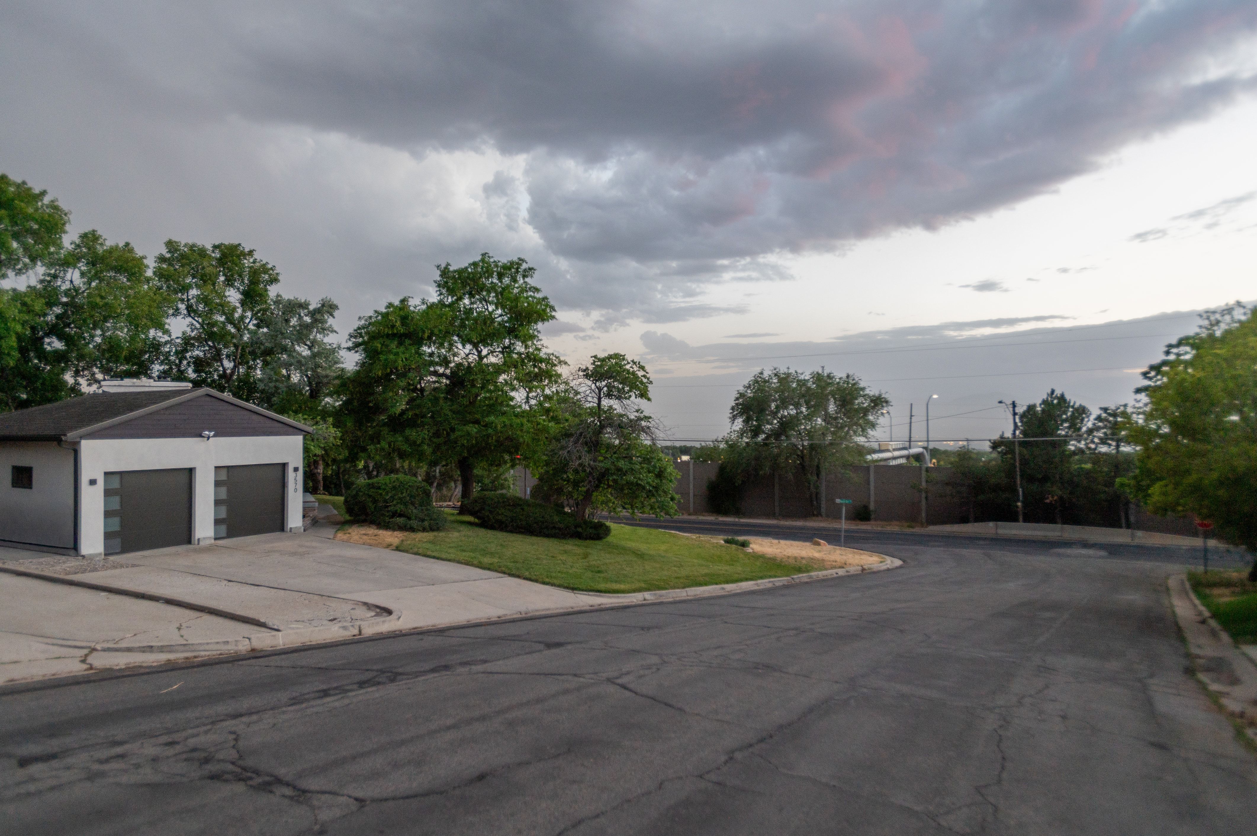 Contemporary detached garage with two garage doors featuring frosted glass panels and an exterior light fixture