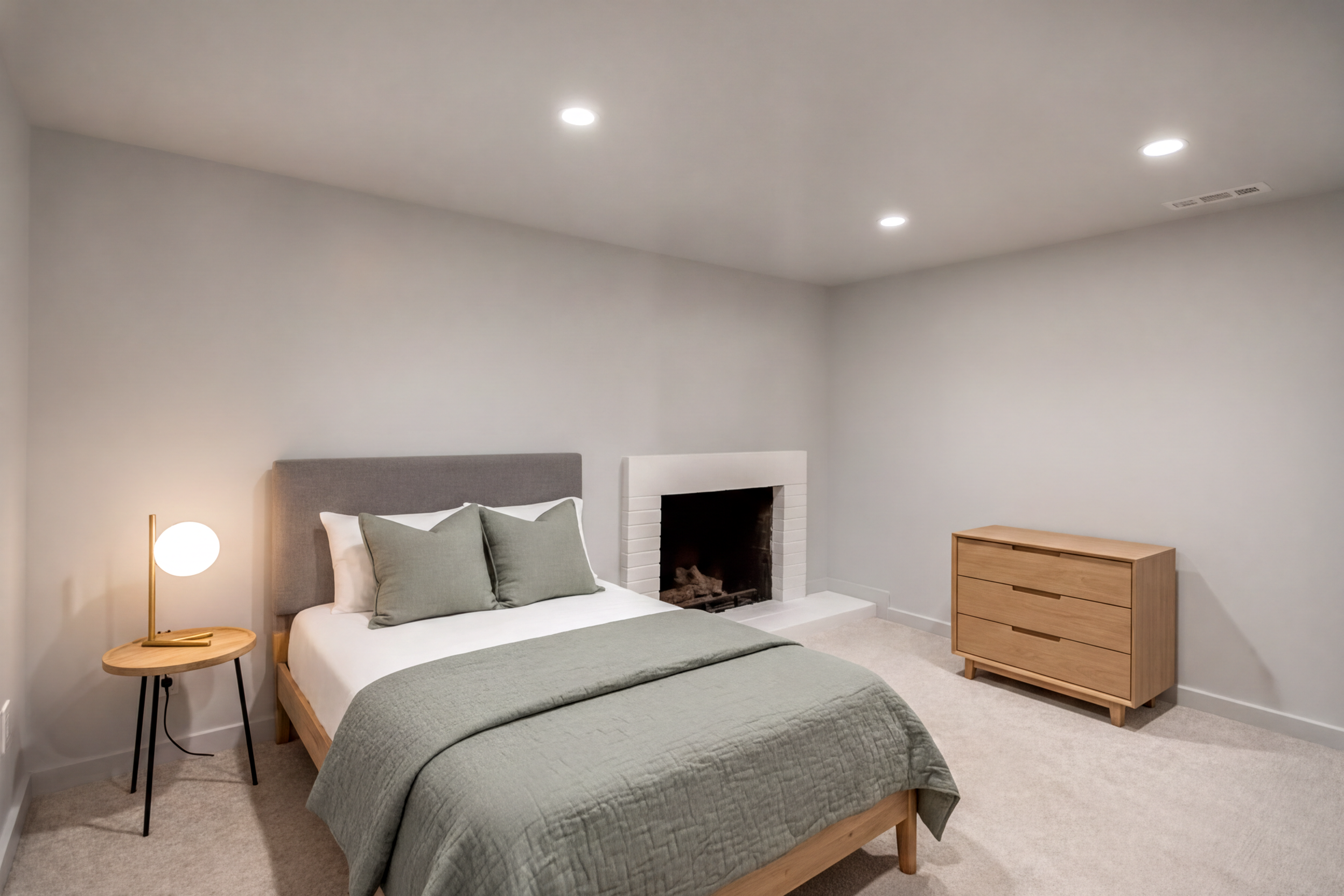 Interior room featuring a white brick fireplace with a raised hearth, light gray carpeting, and recessed lighting. Virtually staged