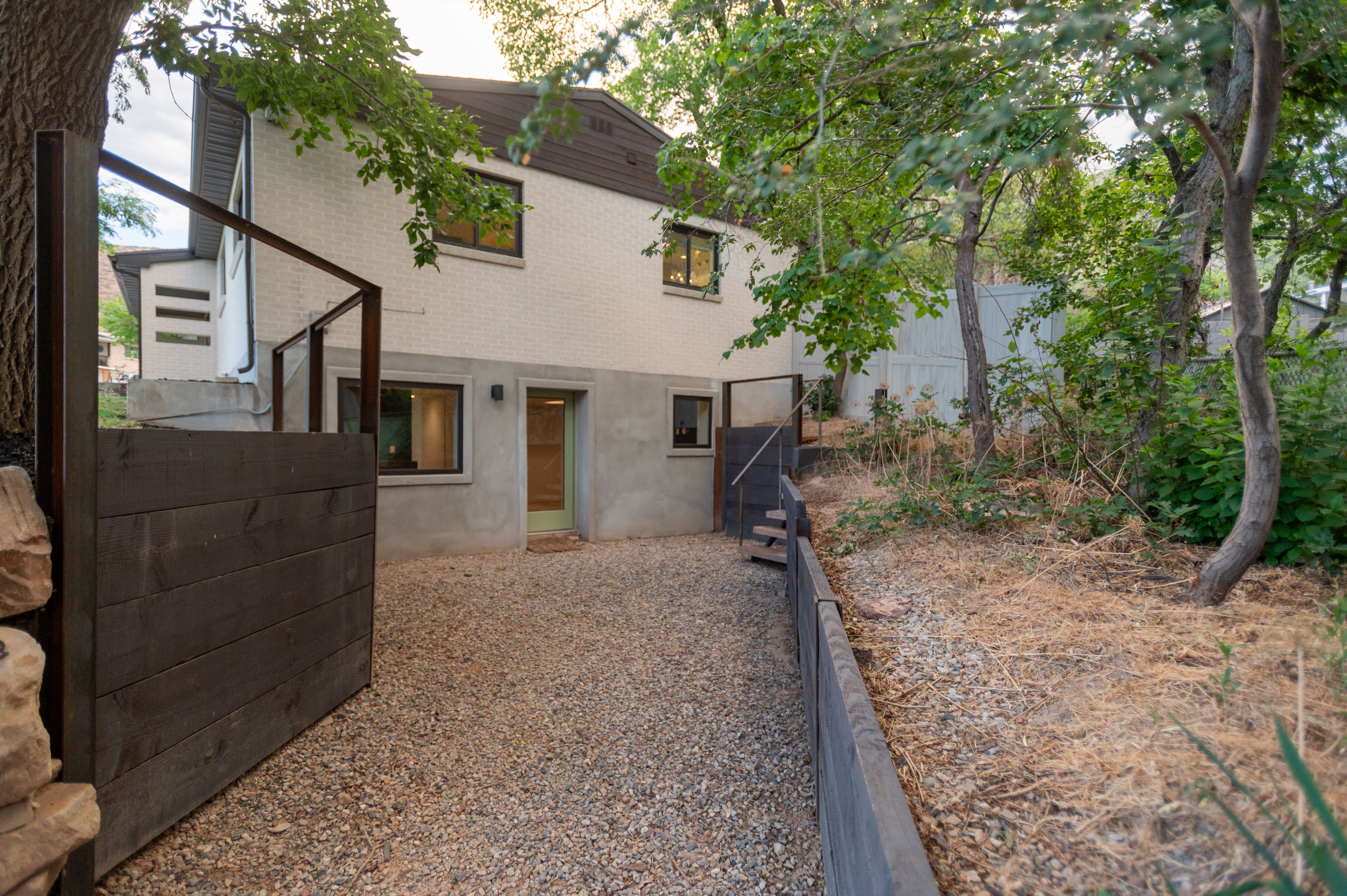 Multi-level exterior with white brick and stucco finishes