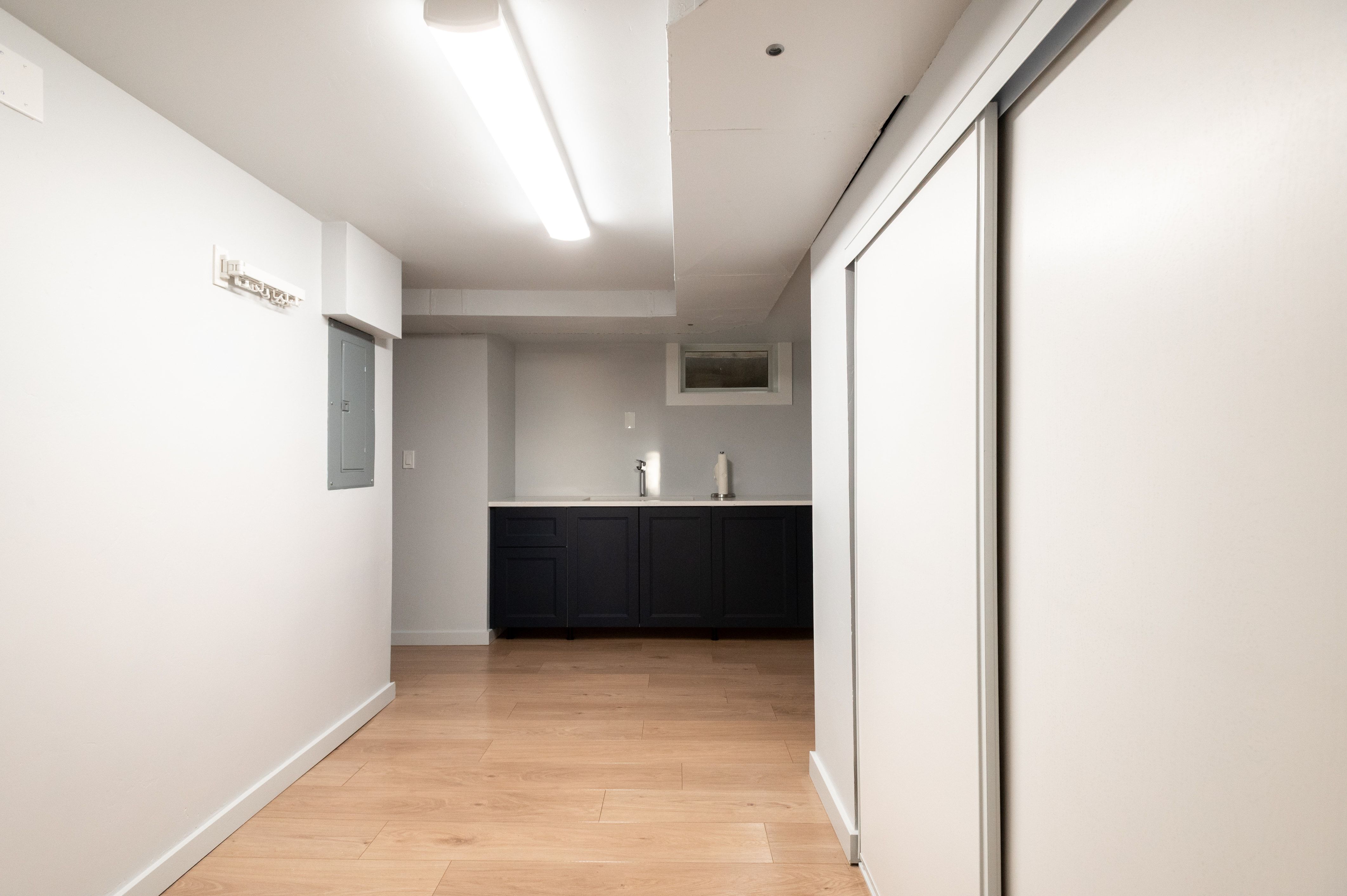 Light wood-finish flooring extending through the space