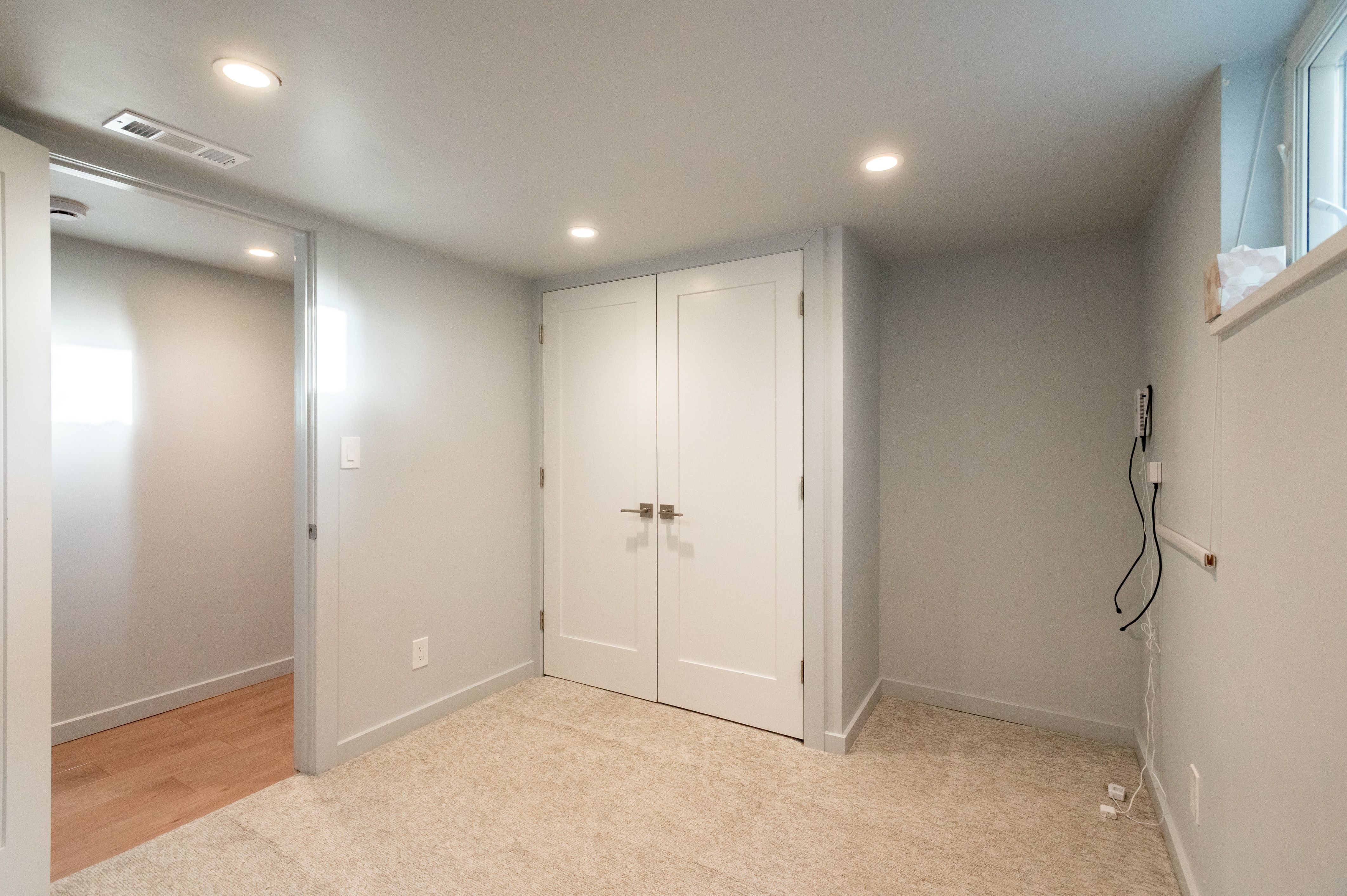 Carpeted room featuring recessed lighting and a window