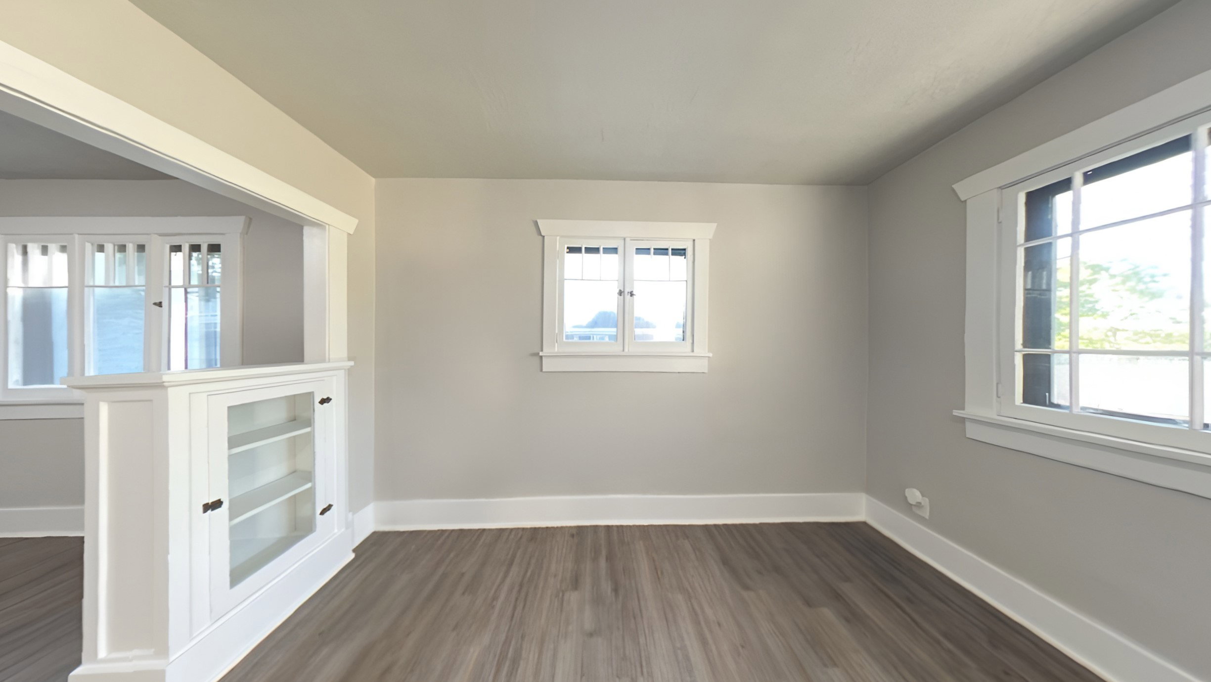 Room featuring wood-finish flooring and light gray painted walls