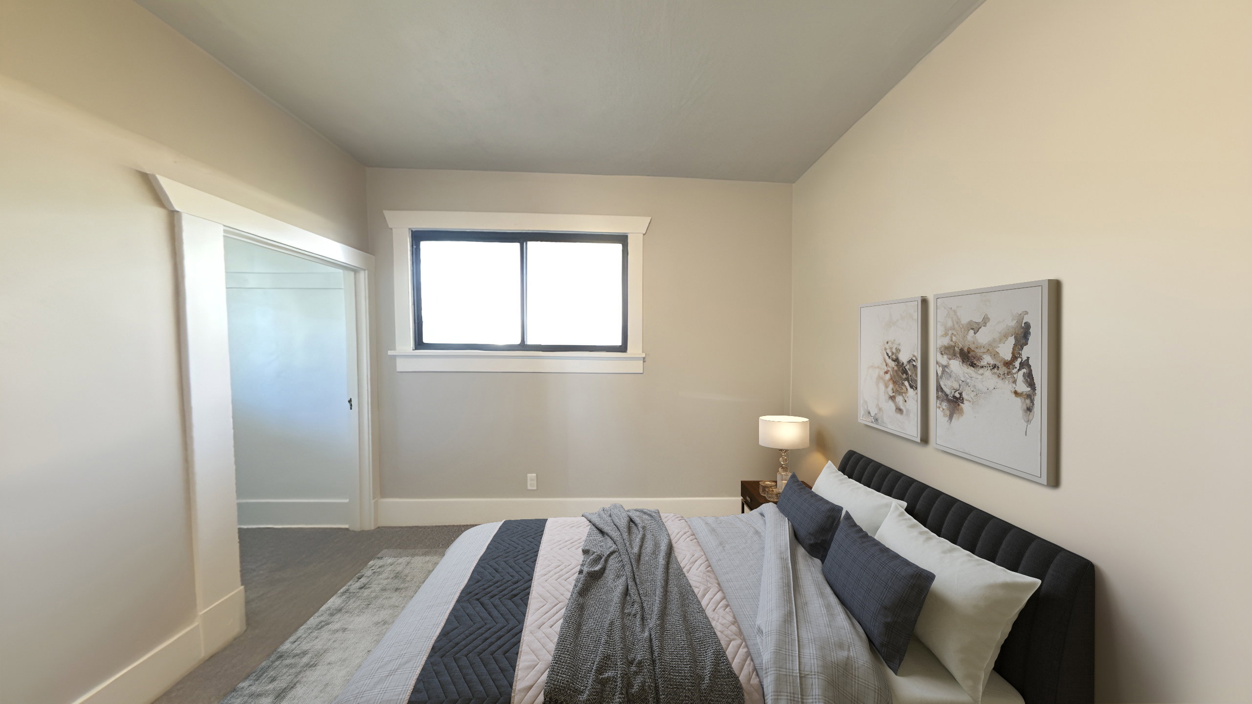 Bedroom featuring neutral wall colors, contrasting window trim, textured carpeting, and a doorway with white trim