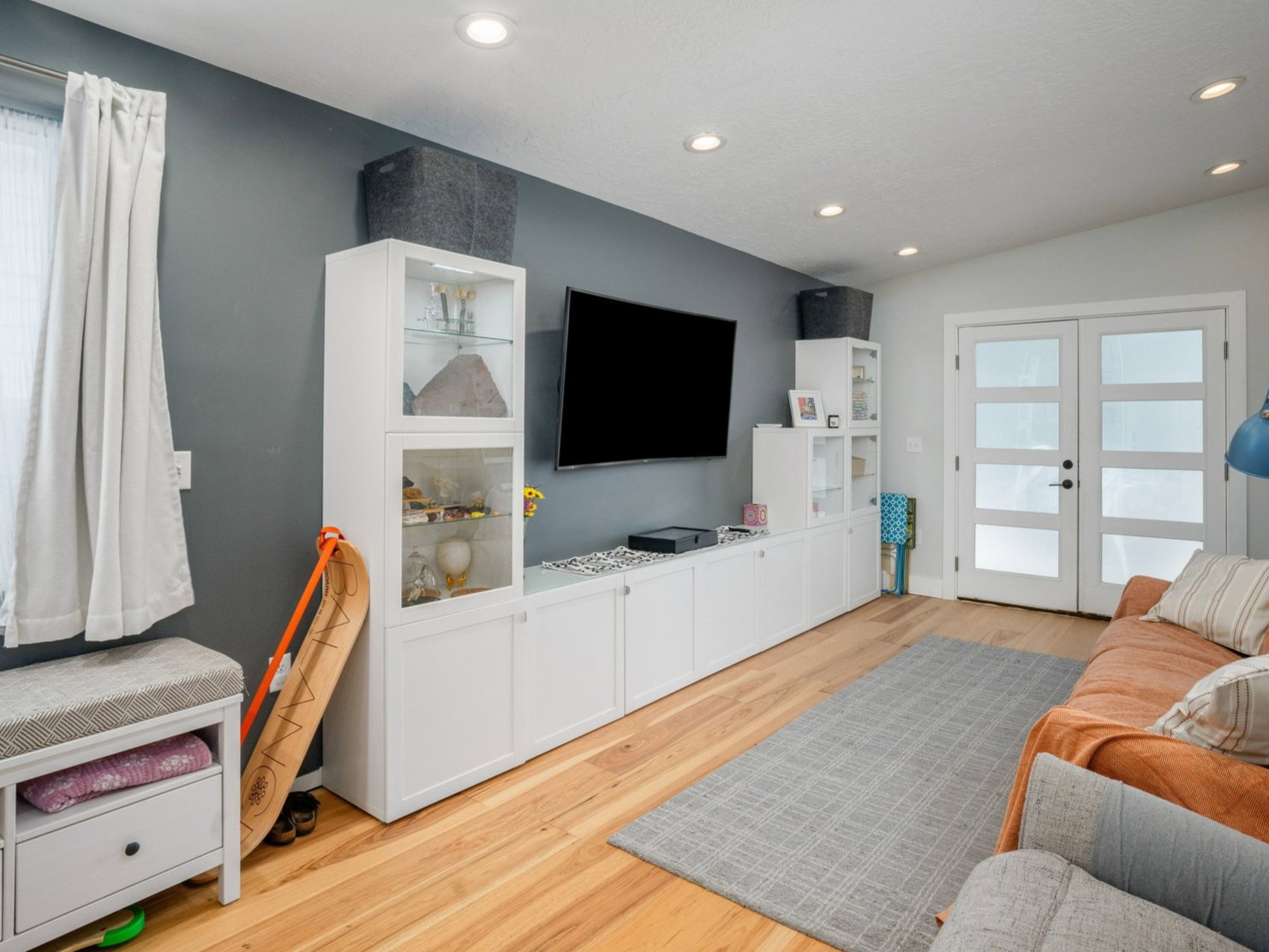 Vaulted ceiling featuring recessed lighting, wood-finish flooring, and white built-in cabinetry