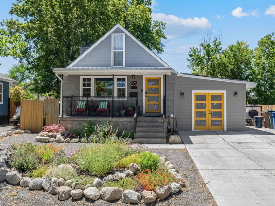 Charming gray home with a gabled roofline and a front porch