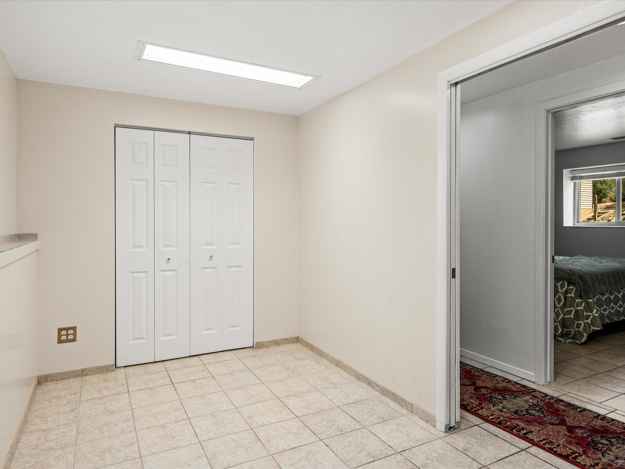 Den with closet and window. Could be used as a home office, gym or 5th bedroom