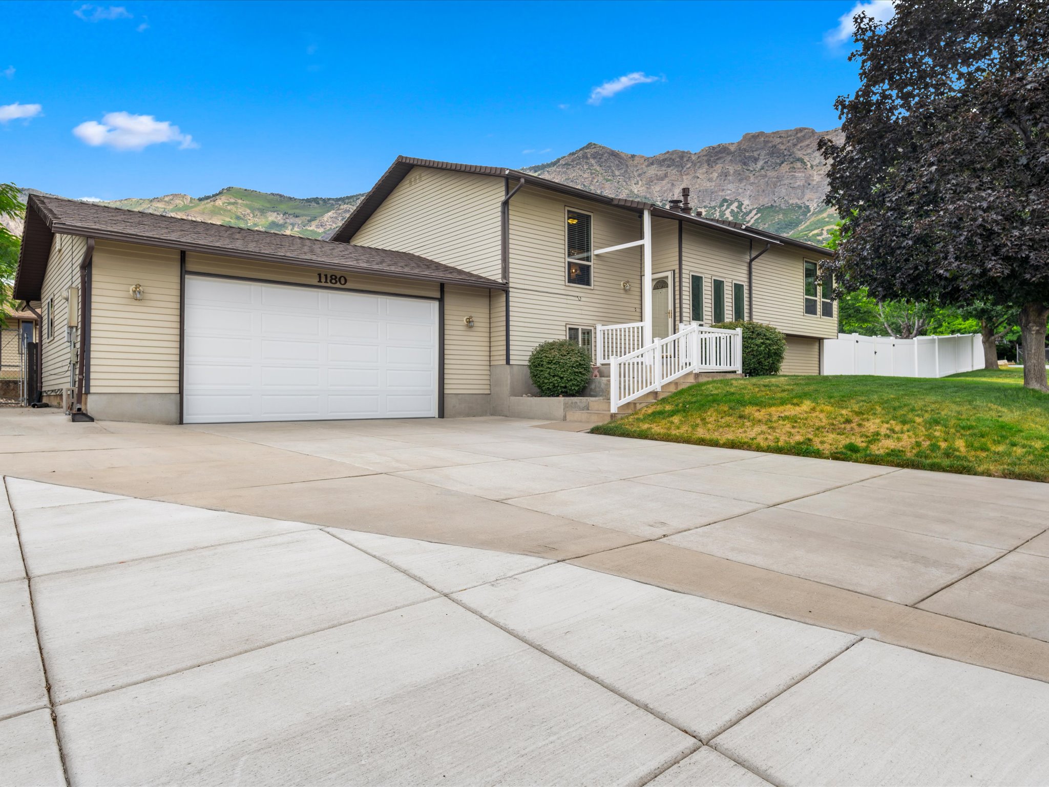 Light-colored siding exterior with a brand new roof, featuring an attached two-car garage and newer garage door.