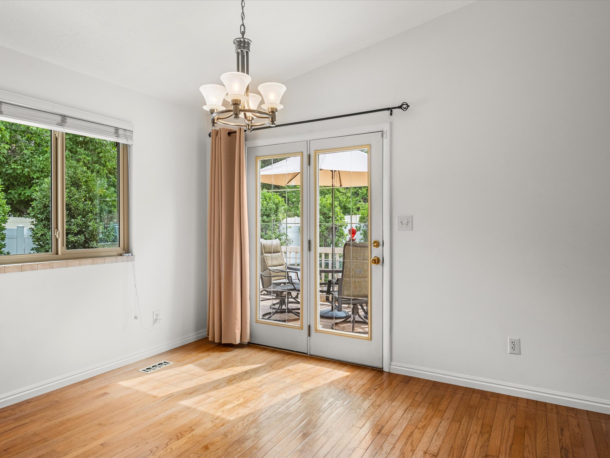 Dining area with hardwood floors and entrance to deck
