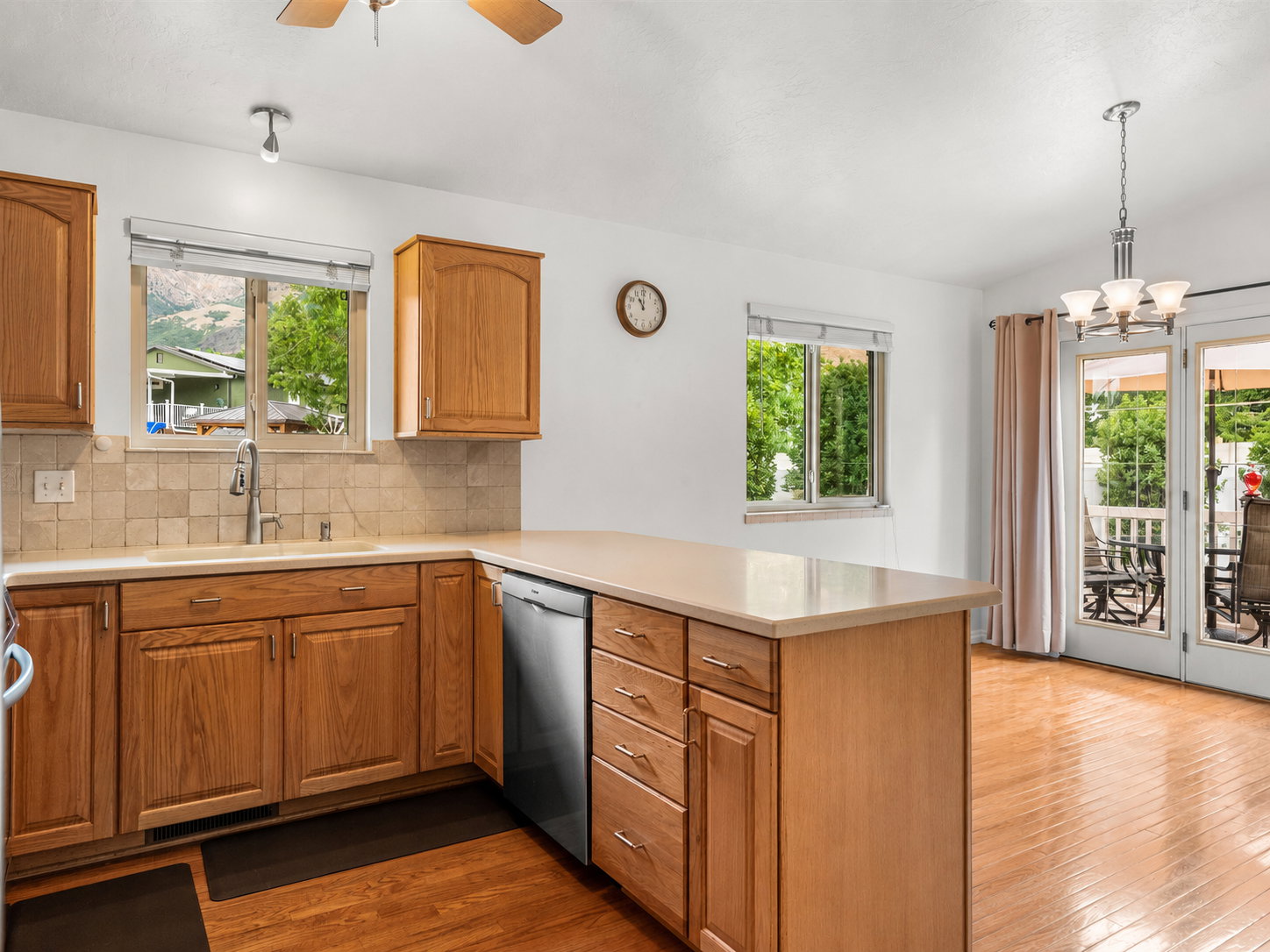Kitchen featuring wood cabinetry, light-toned countertops, and a tiled backsplash