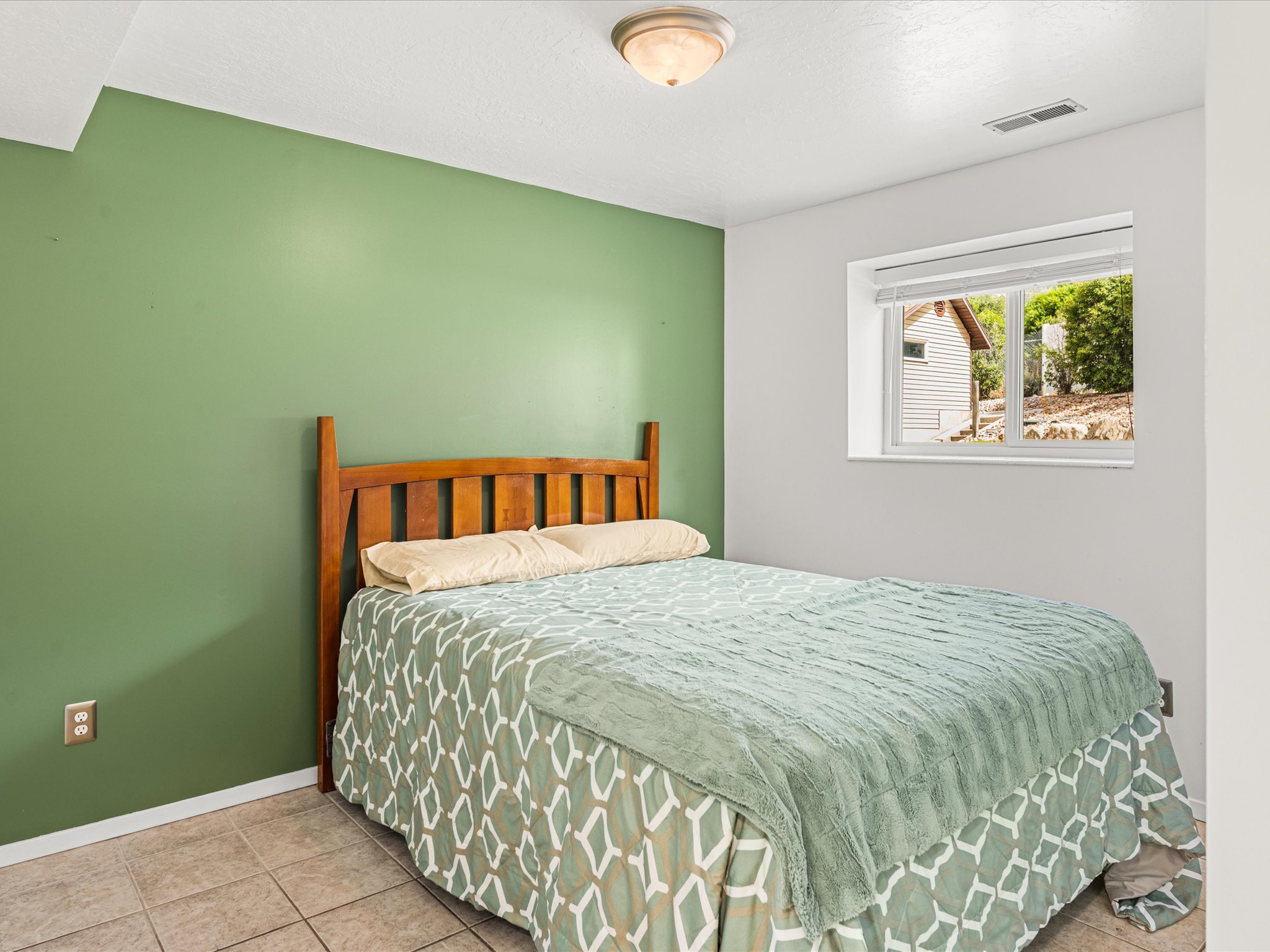 Bedroom with a single window, recessed lighting, and tile flooring