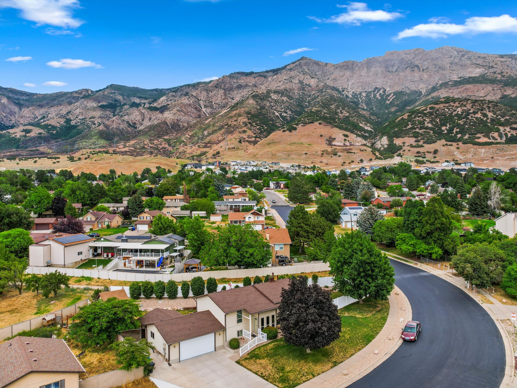 Aerial perspective showcasing a residential neighborhood with mountain backdrop