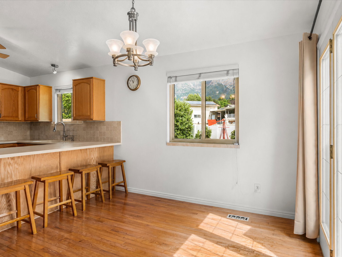 Dining area featuring wood flooring and a multi-light chandelier