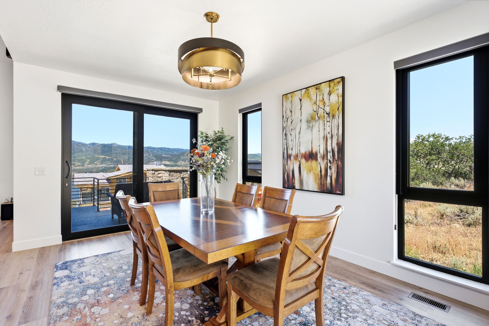 Dining area featuring a contemporary chandelier and wood-finish flooring