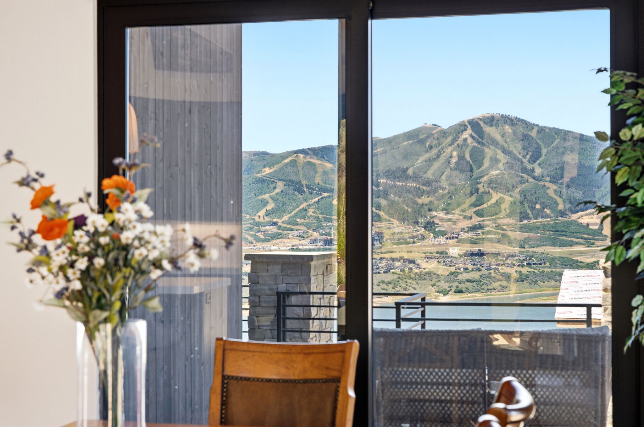 Expansive glass doors opening to a mountainous landscape