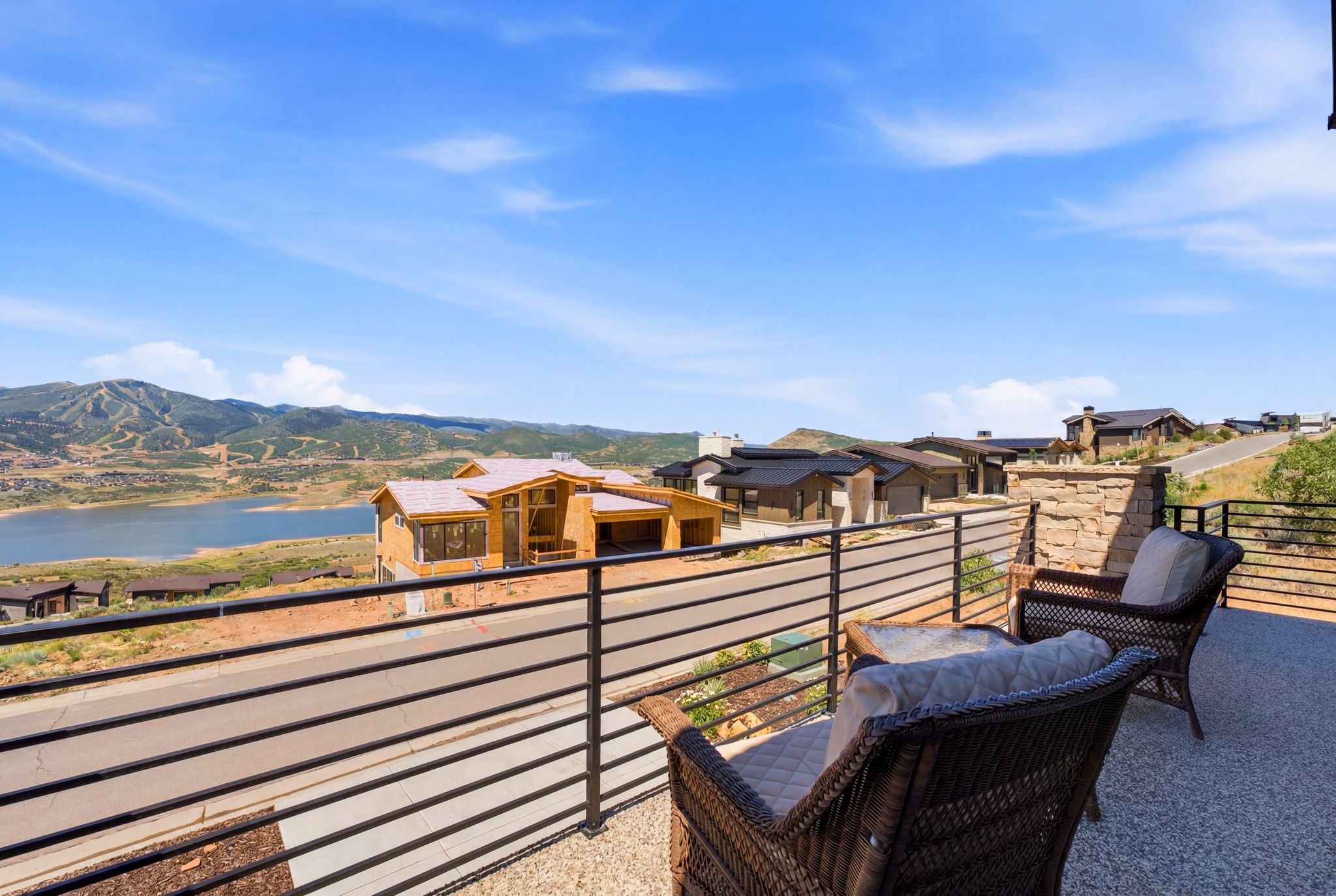 Spacious outdoor balcony with a black horizontal slat railing