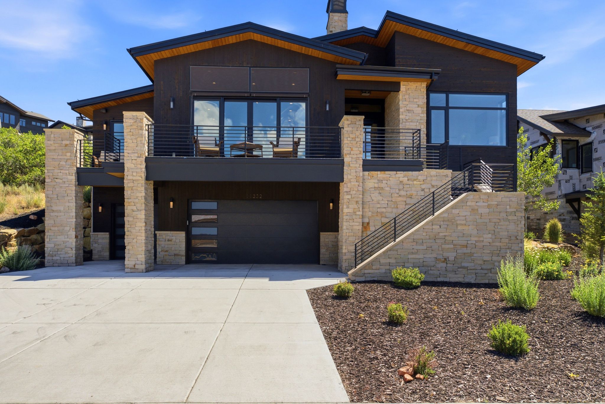 Contemporary architectural design featuring dark siding and stone cladding