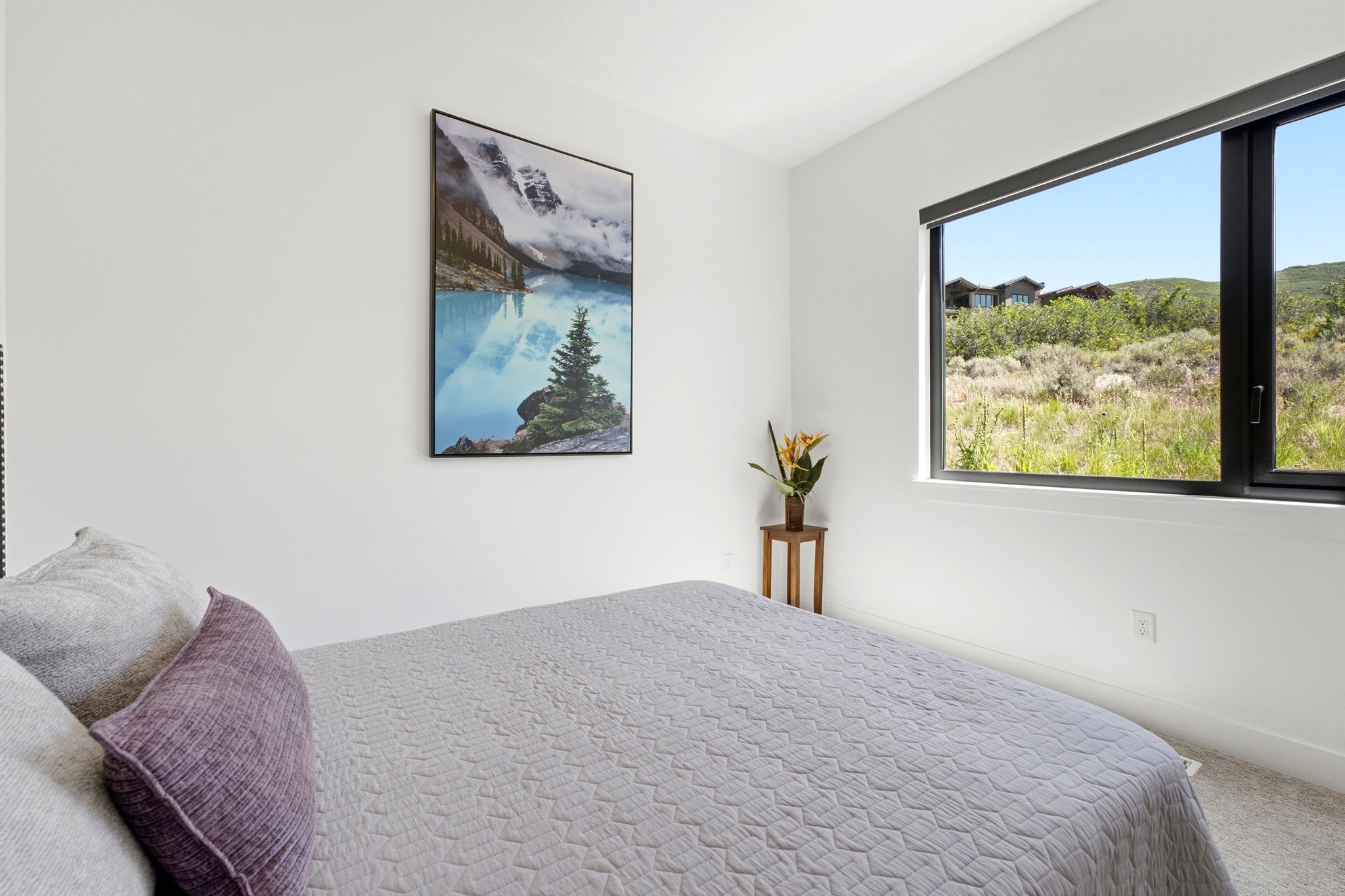 Neutral white walls complement the carpeted flooring