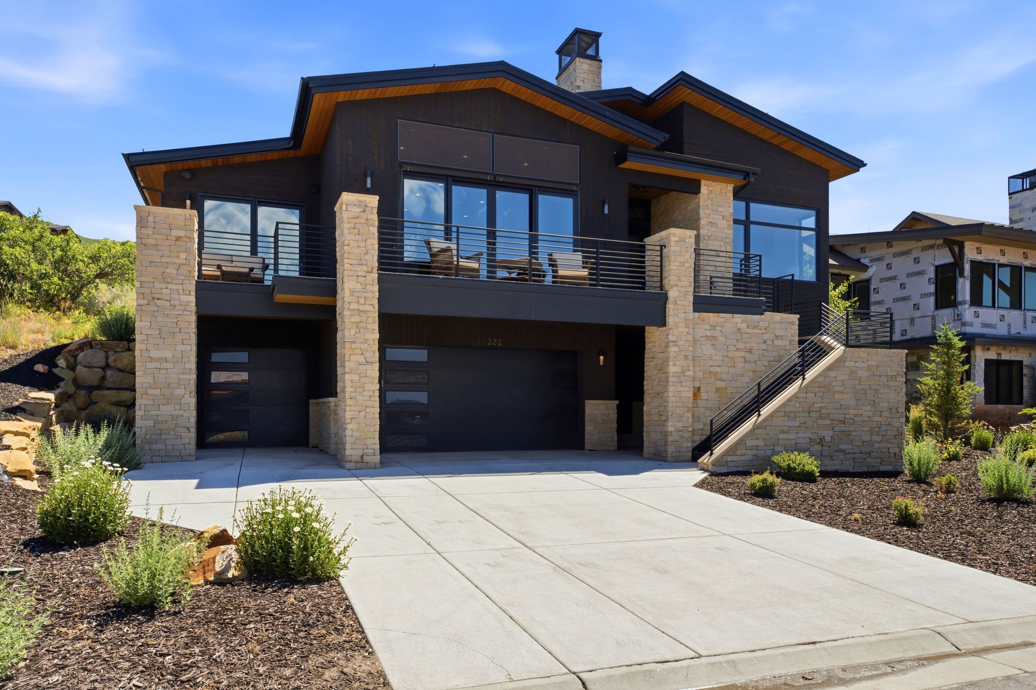 Modern architectural residence with dark exterior siding and expansive windows