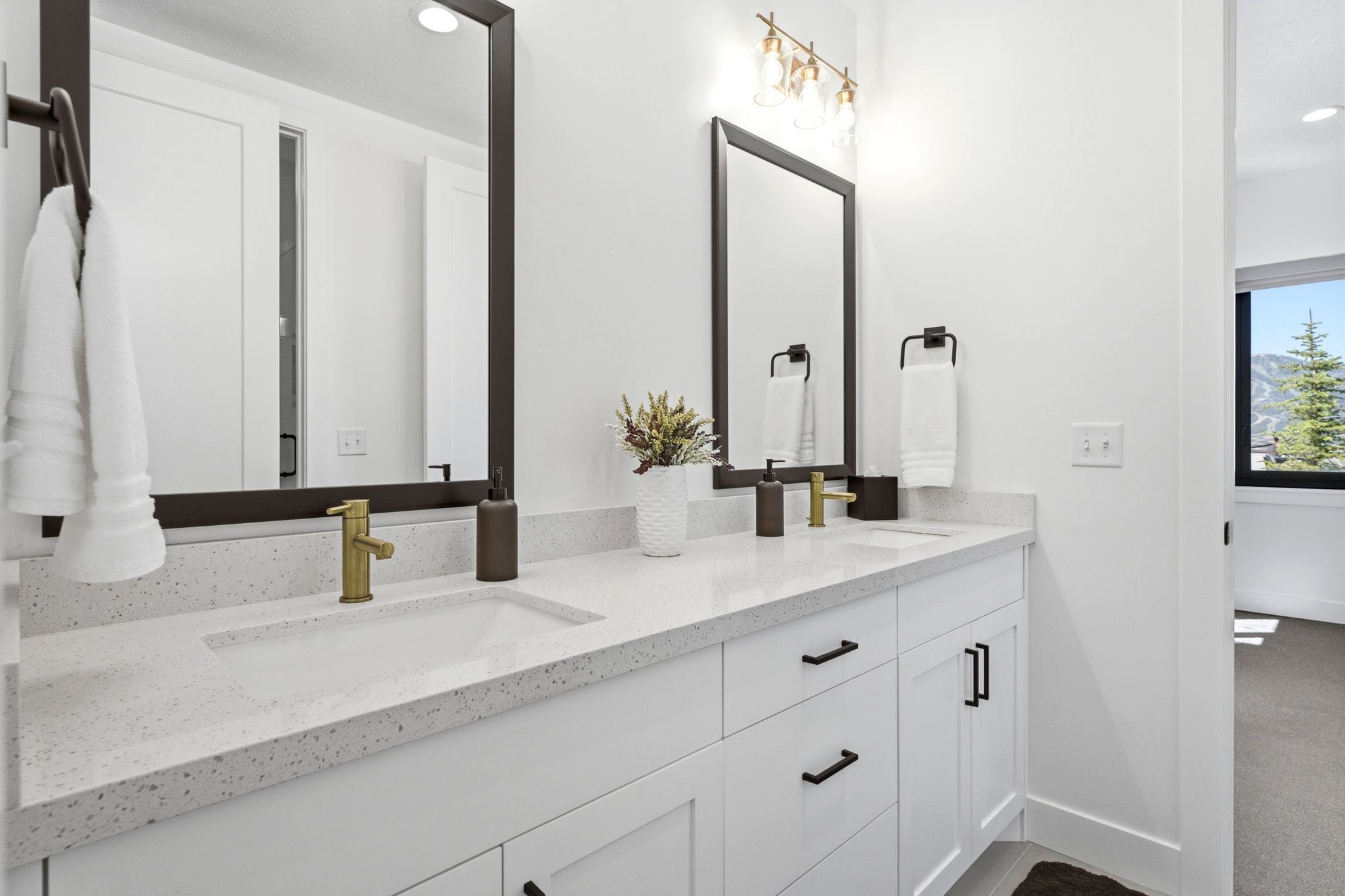 Dual vanity featuring gold-finish faucets and undermount sinks