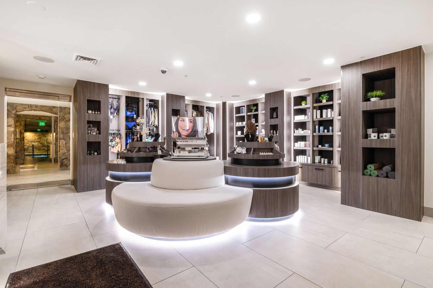 Contemporary retail space featuring integrated wood-finish display shelving and built-in cabinetry