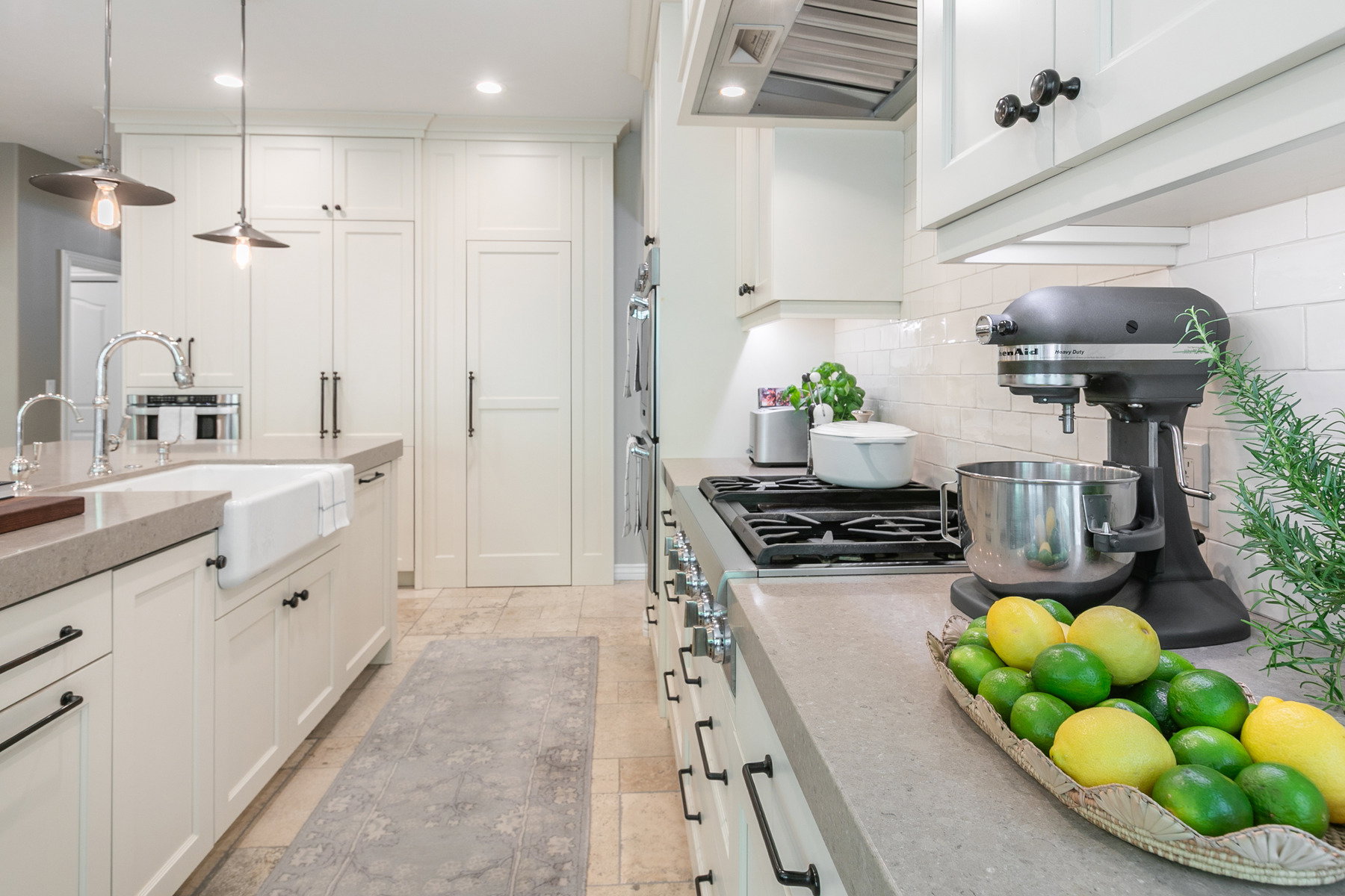 Gourmet kitchen featuring a gas range, subway tile backsplash, and extensive cabinetry