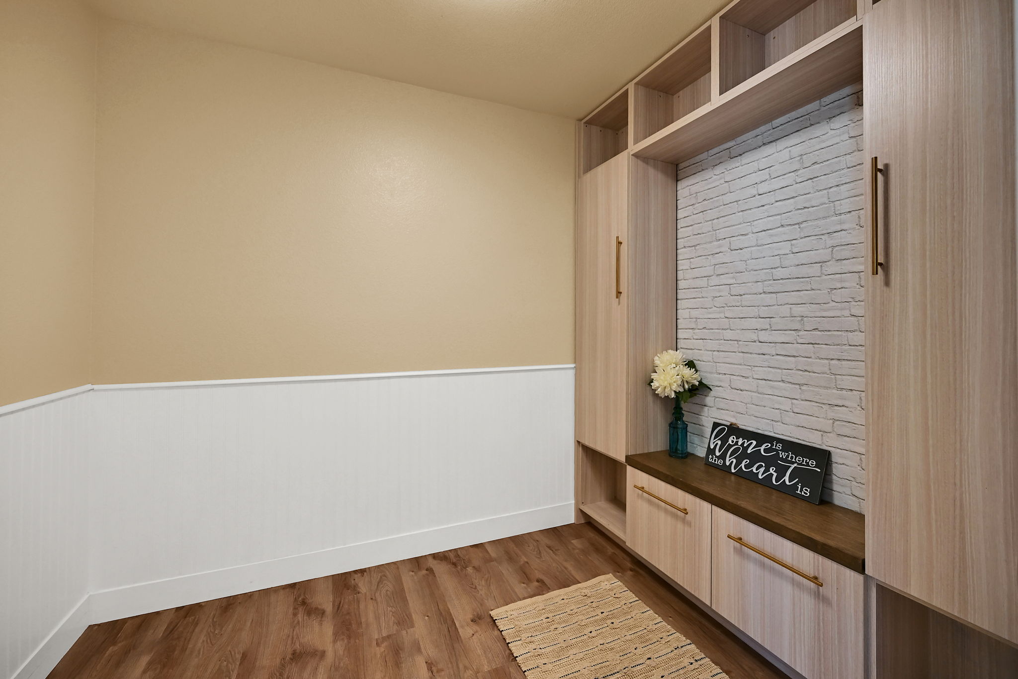 Built-in storage cabinetry featuring wood-finish panels and gold-tone hardware